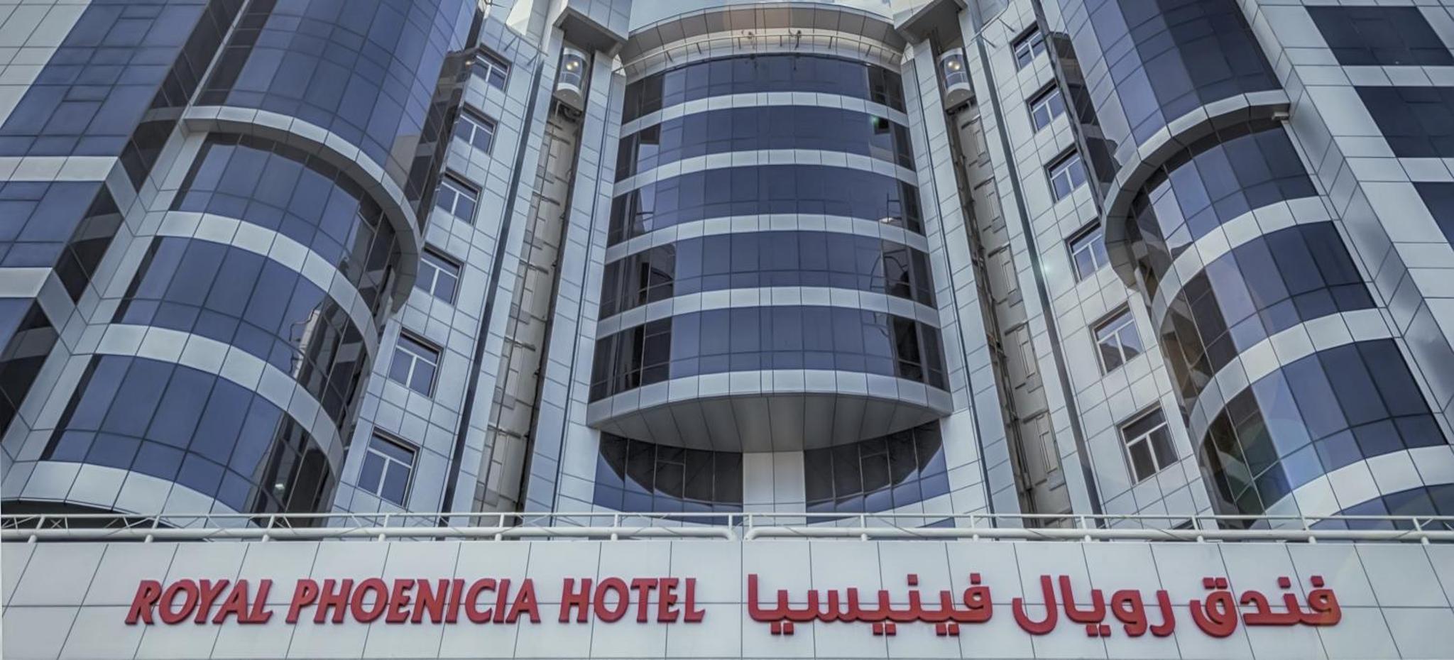 a building with a hotel sign in front of it at Royal Phoenicia Hotel in Manama