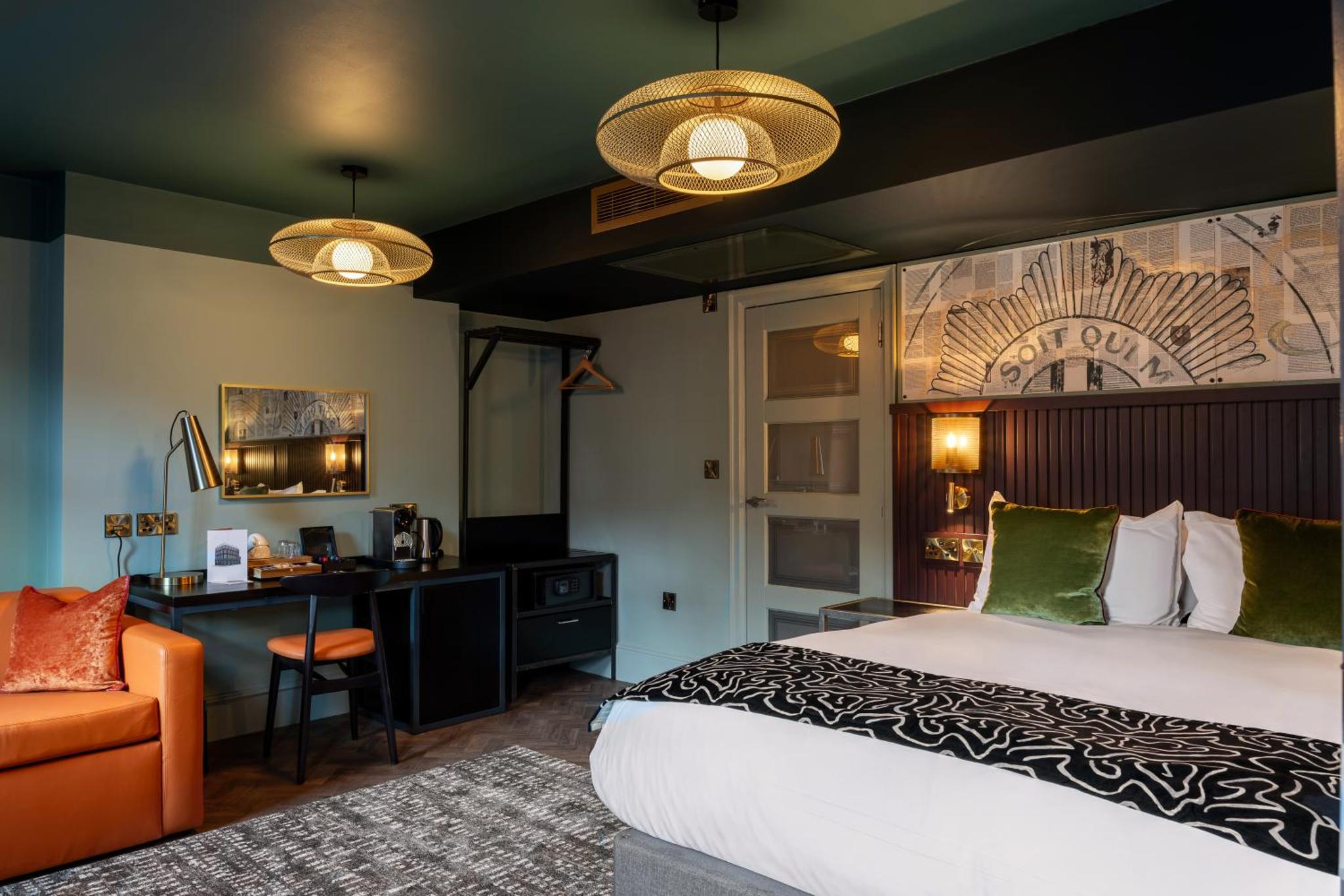 a hotel room with a bed and a desk at The Wellington Hotel in London