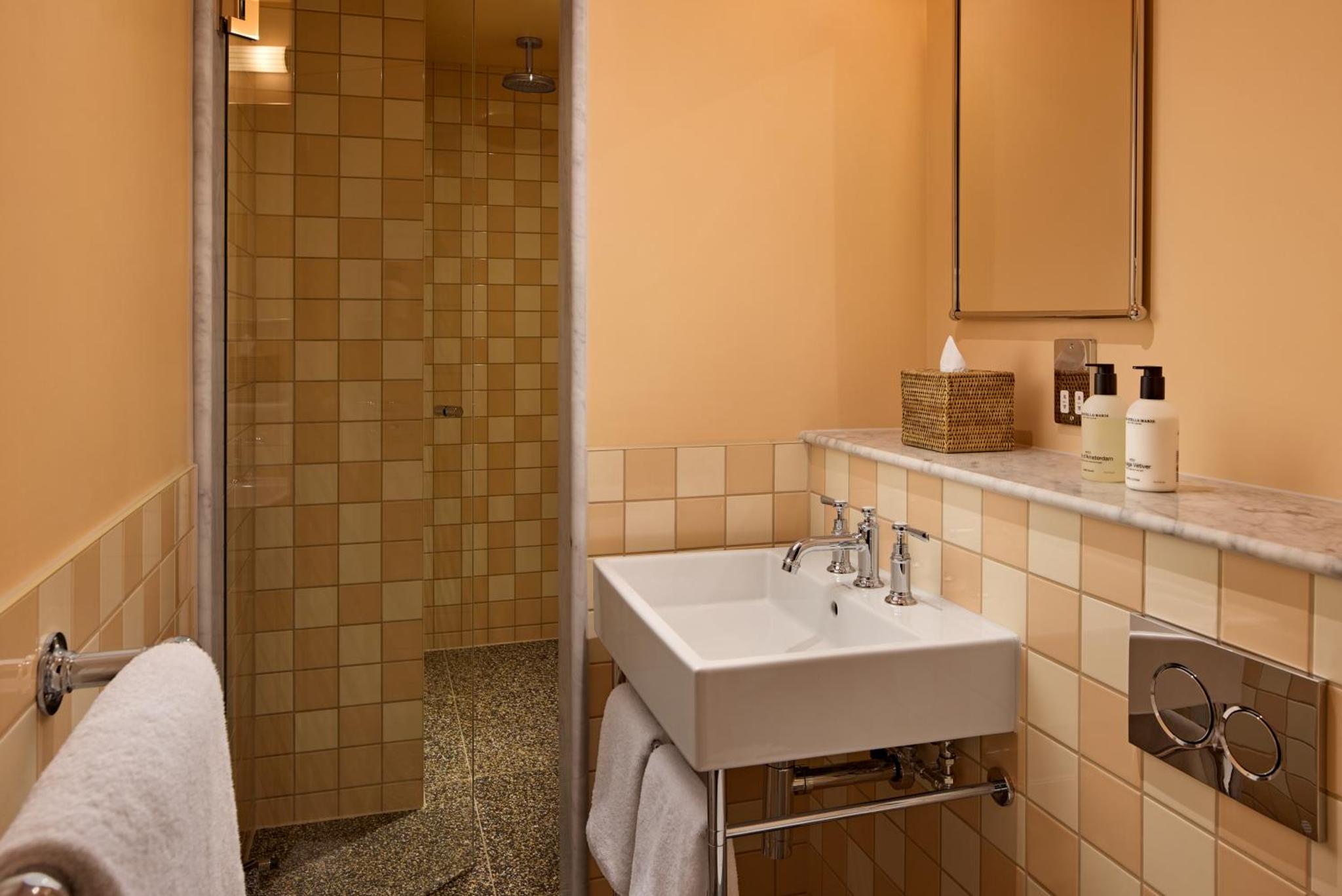 a bathroom with a sink and a shower at The July - London Victoria in London