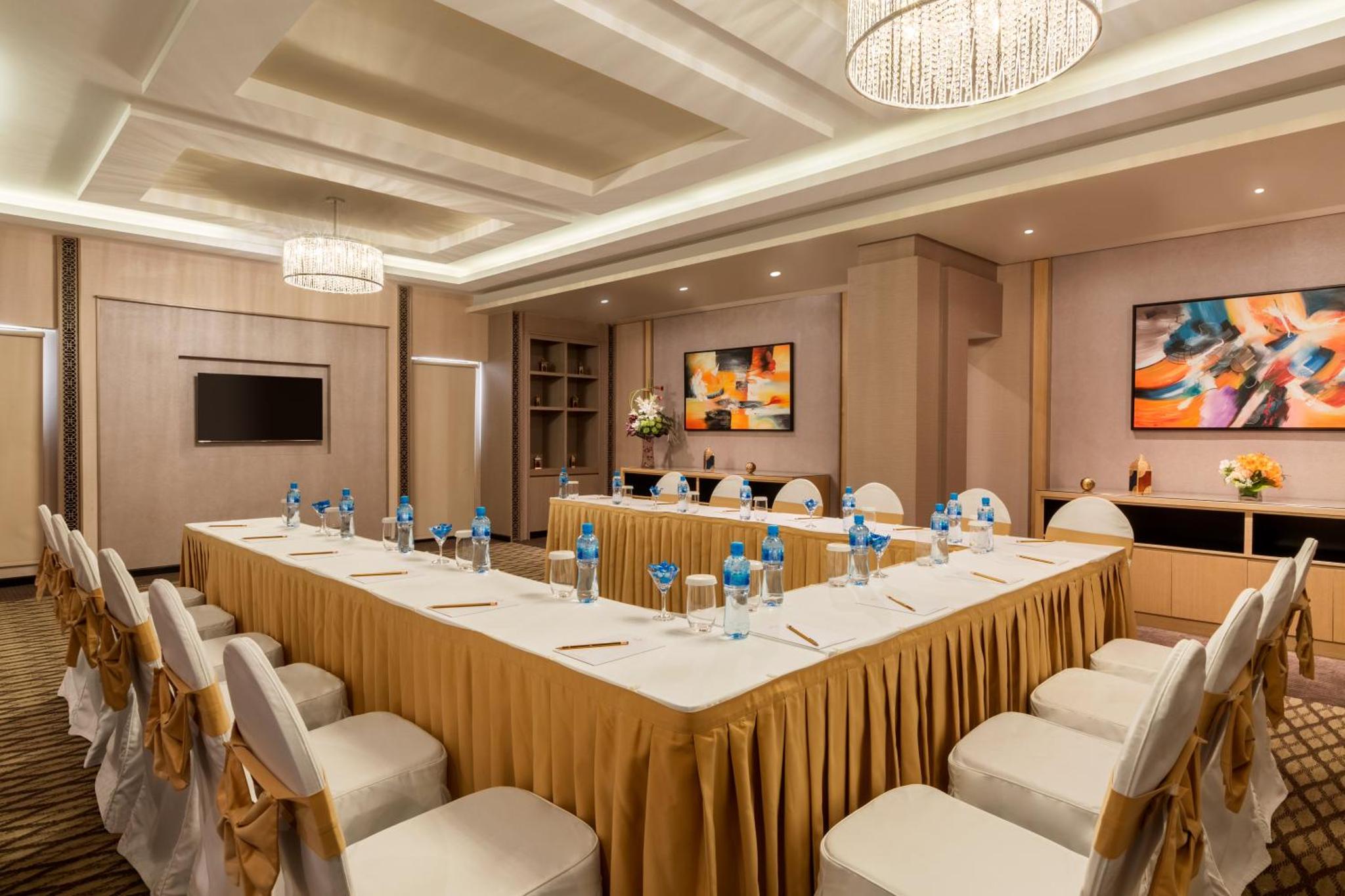 a large conference room with a long table and chairs at Ramada Hotel and Suites Amwaj Islands in Manama +87 photos