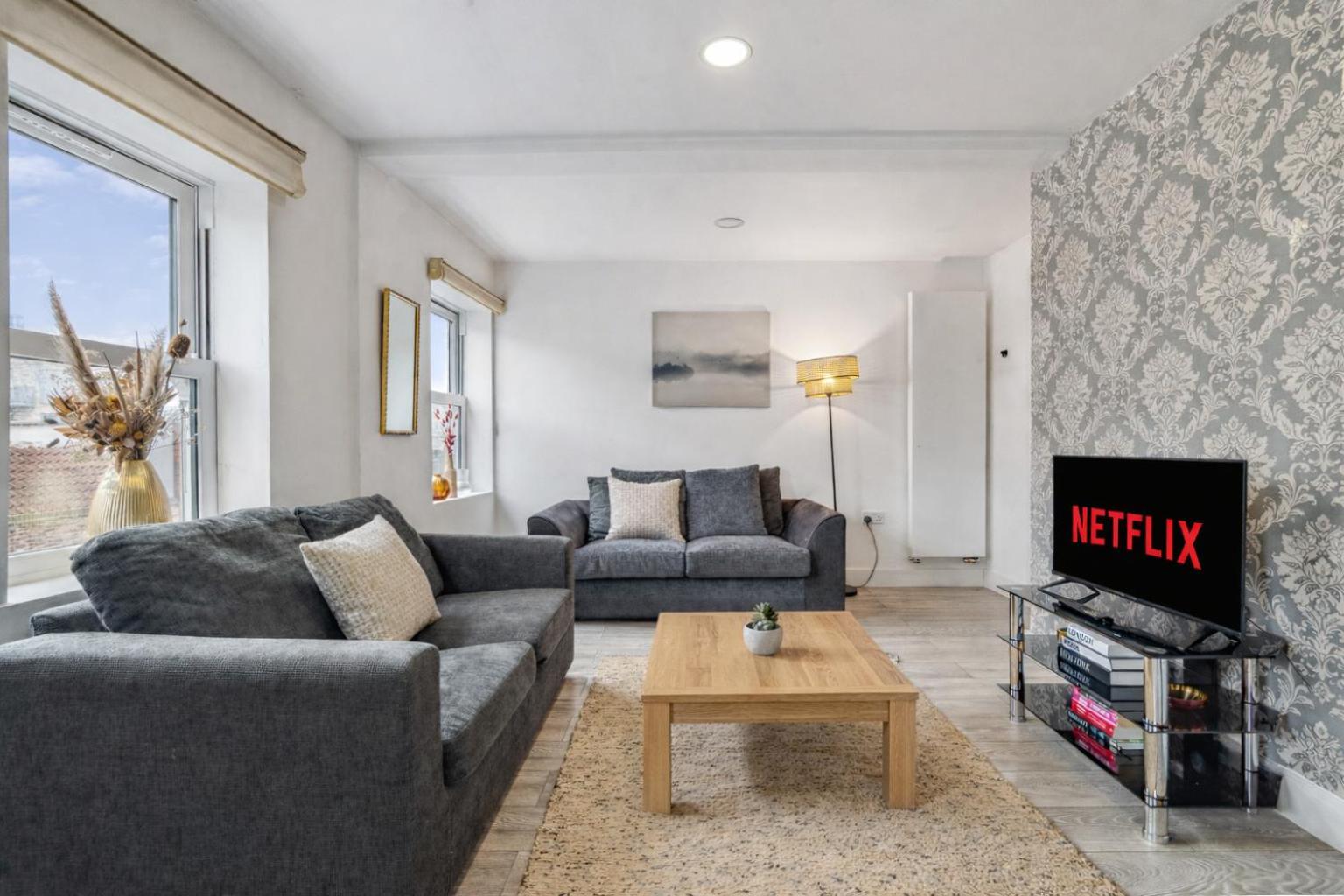 a living room with two couches and a tv at Keyhol Short Stay I Trendy Flat I Bricklane Market in London