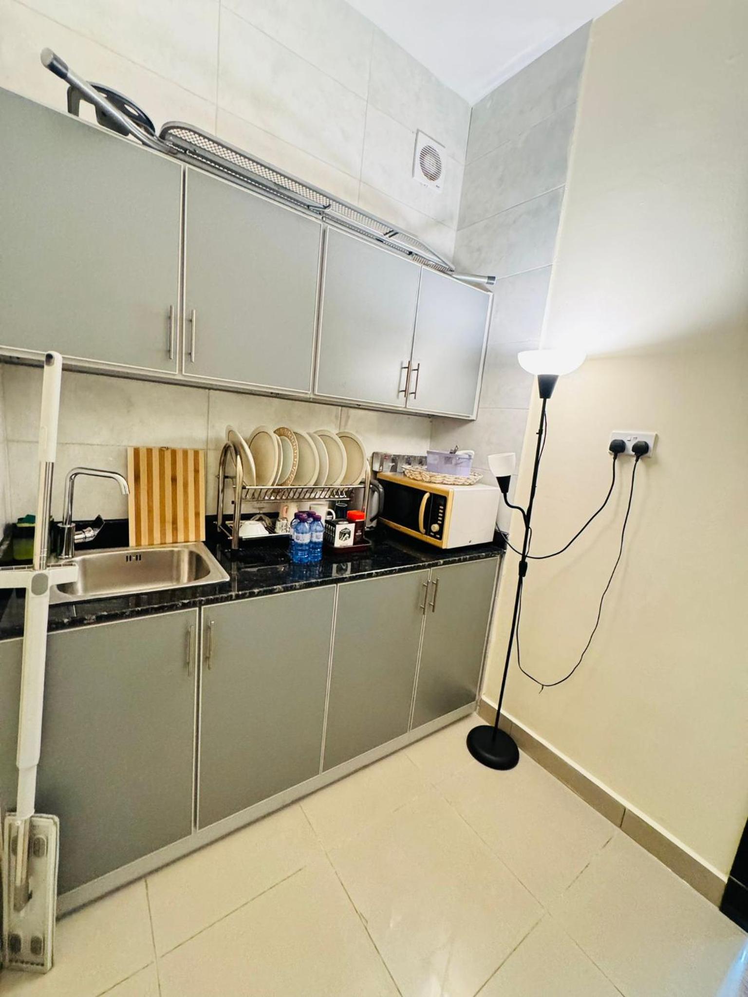 a kitchen with a lamp in the middle of a kitchen at Luxurious Cozy Studio Flat Message whatsap below for bookings in Sanābis
