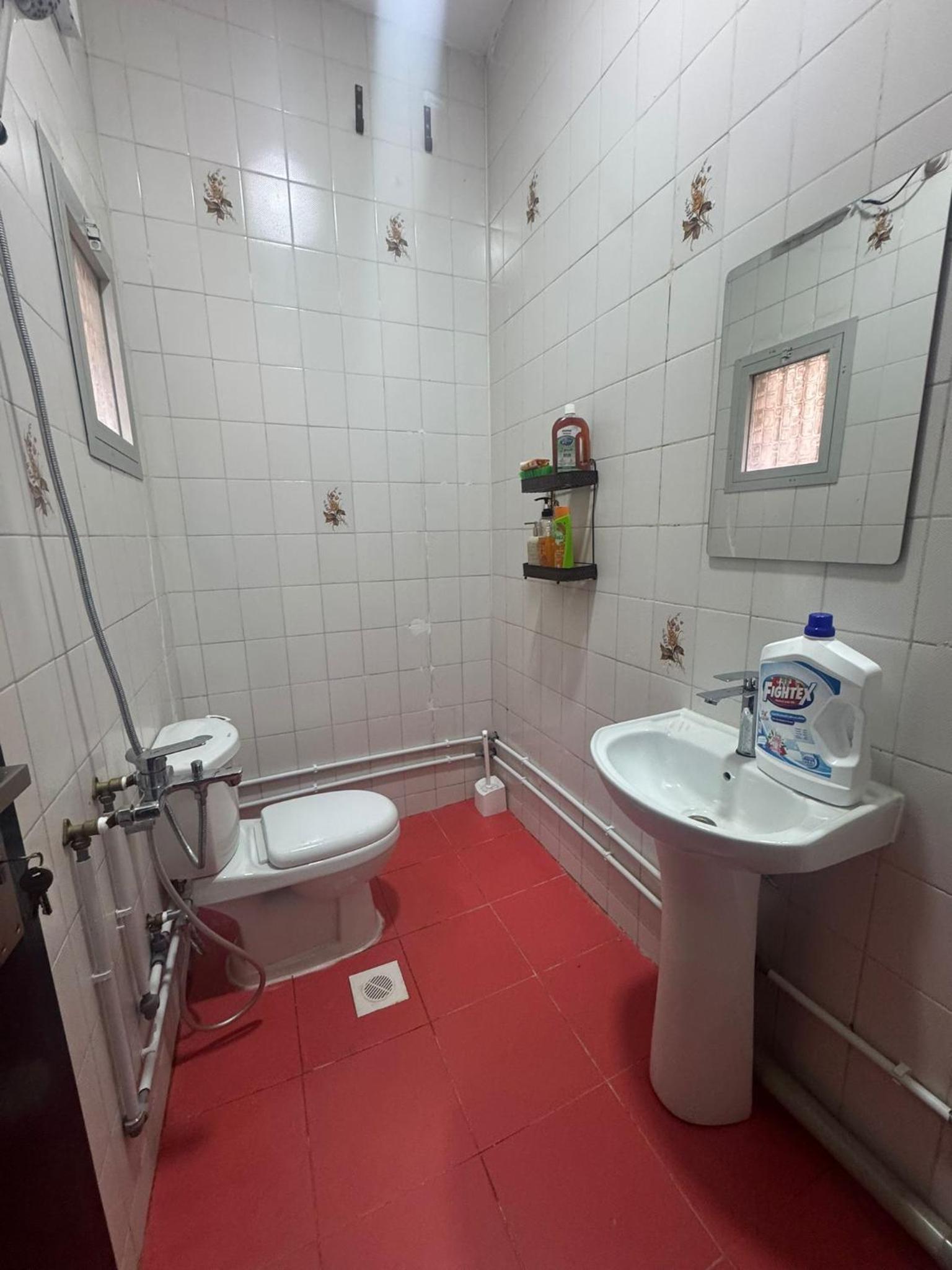 a bathroom with a white toilet and a sink at Luxurious Cozy Studio Flat Message whatsap below for bookings in Sanābis