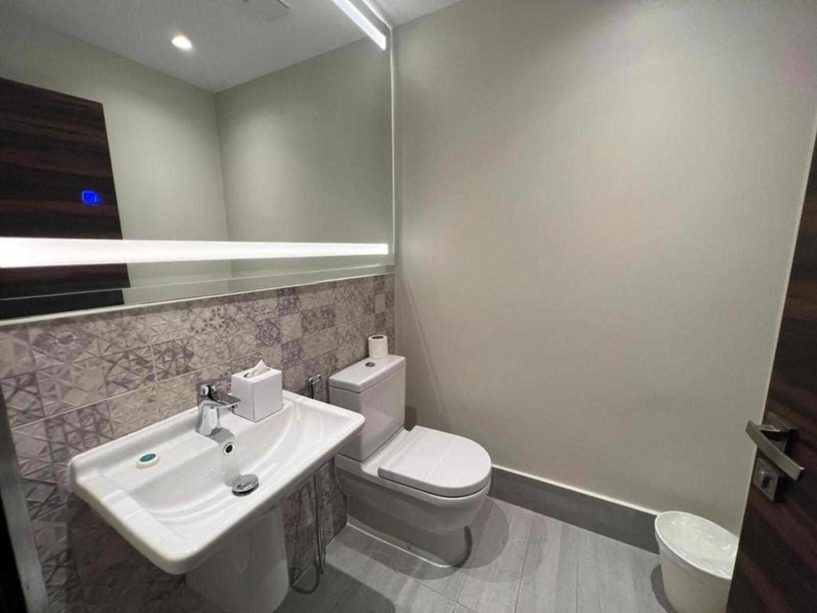 a bathroom with a white toilet and a sink at Luxury Villa with Private Swimming Pool in Manama +24 photos