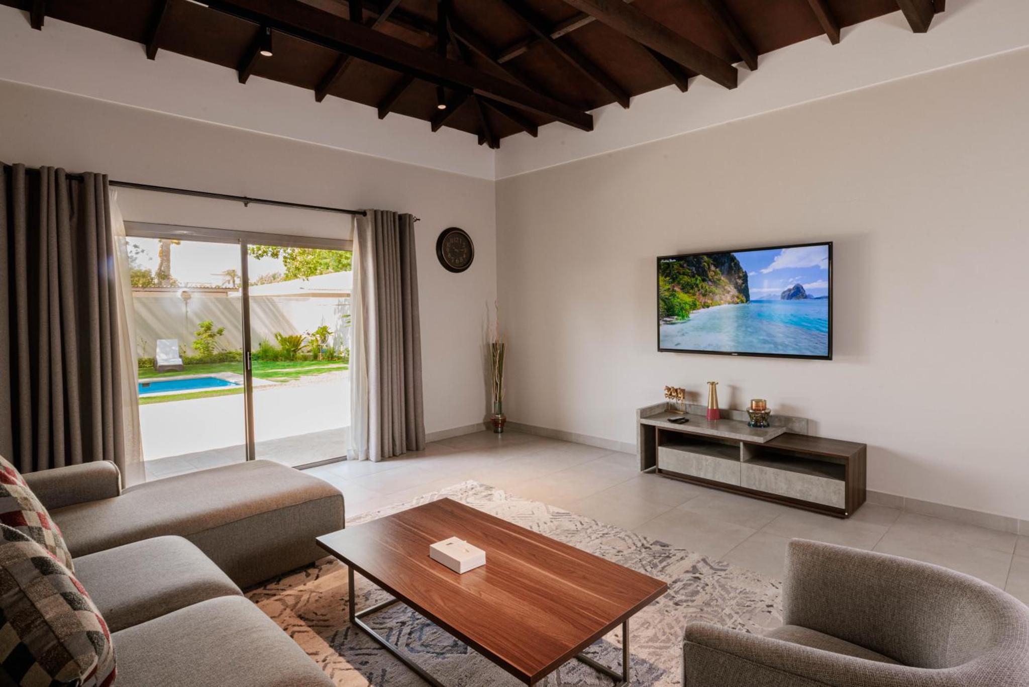 a living room with a couch and a table at Luxury Villa with Private Swimming Pool in Manama