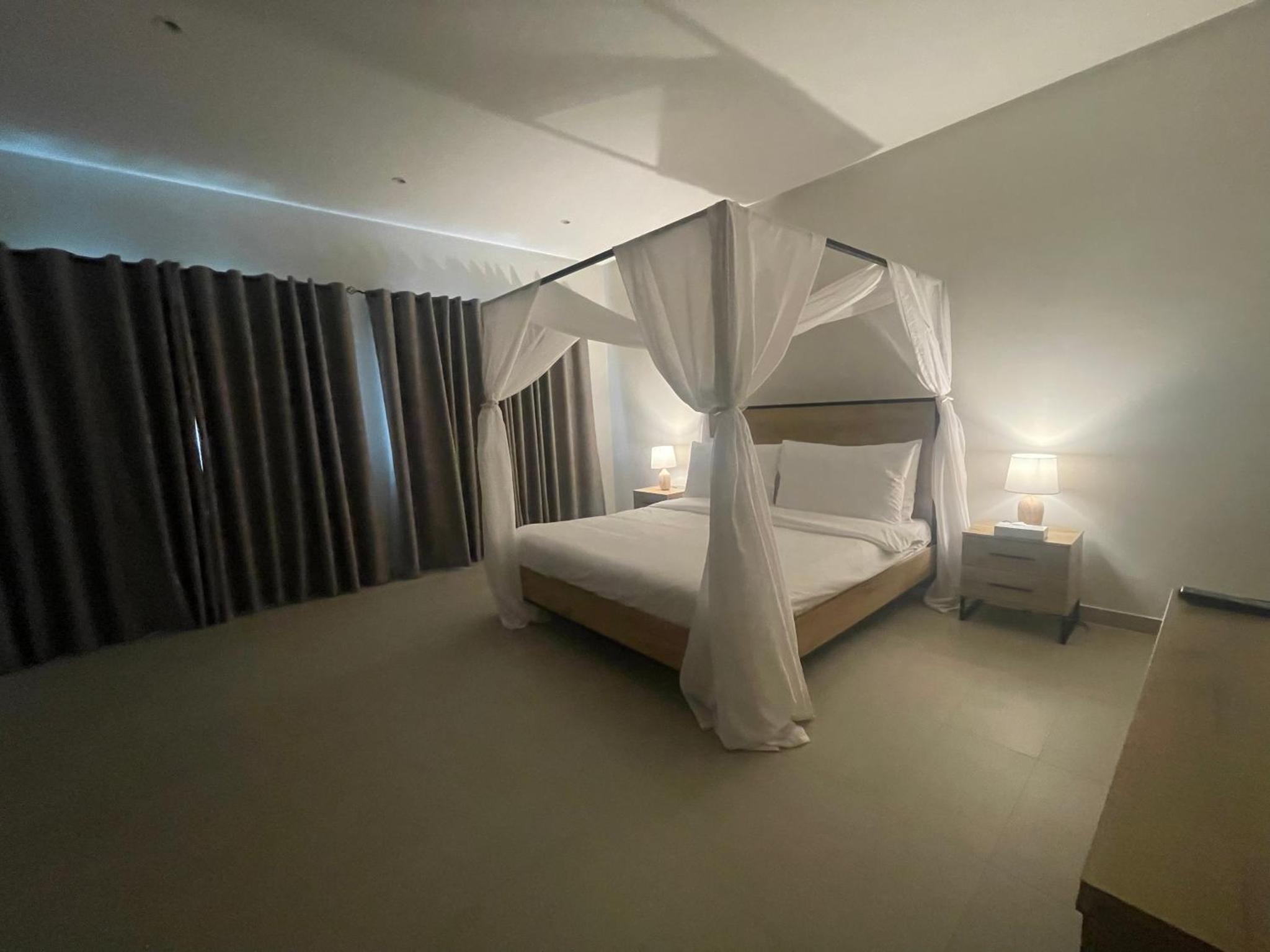 a bedroom with a bed with a canopy at Luxury Villa with Private Swimming Pool in Manama