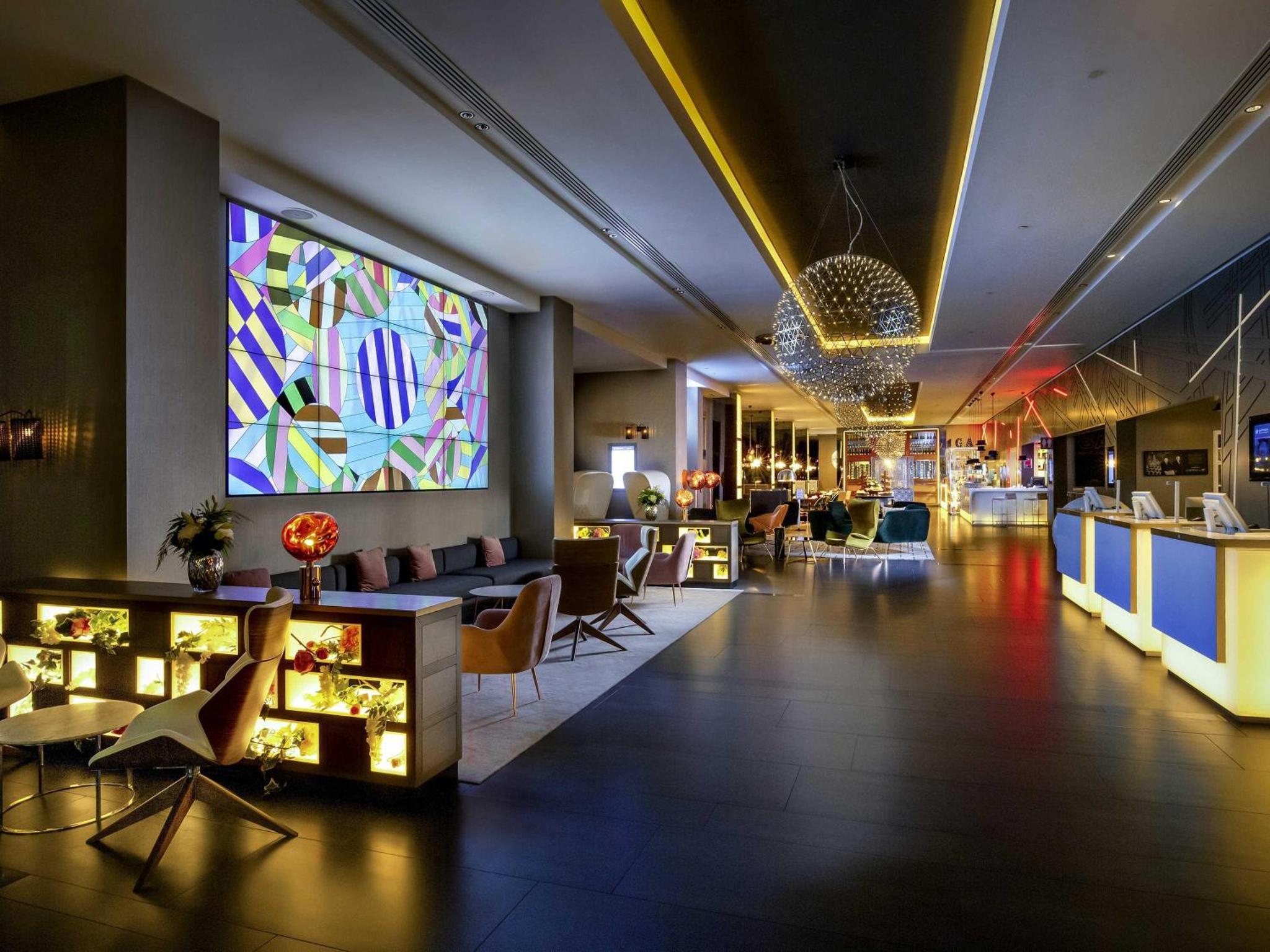 a lobby of a hotel with a stained glass window at Pullman London St Pancras in London