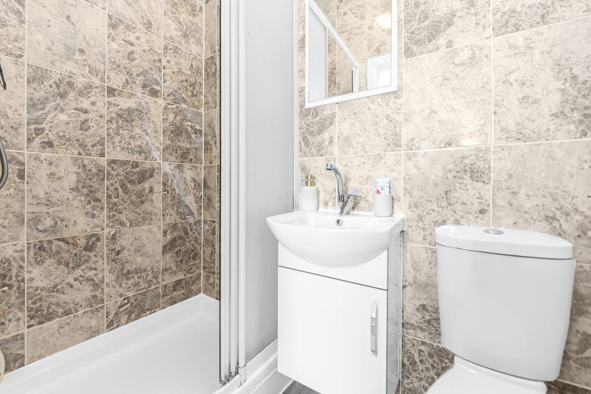 a bathroom with a toilet and a sink at Beautiful Stay Camden, 4 Minutes to King s Cross Station in London