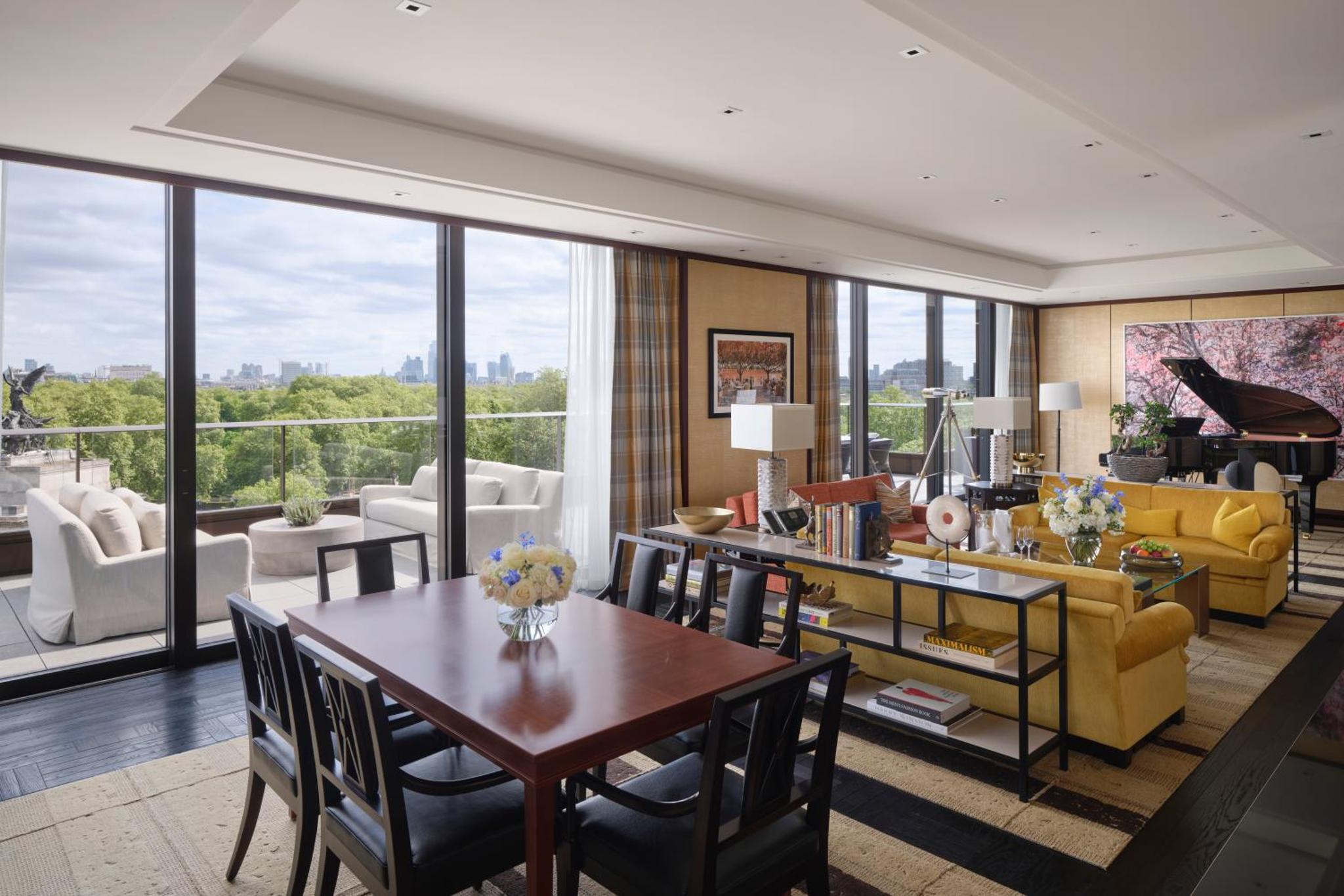 a living room with a table and chairs at The Peninsula London in London