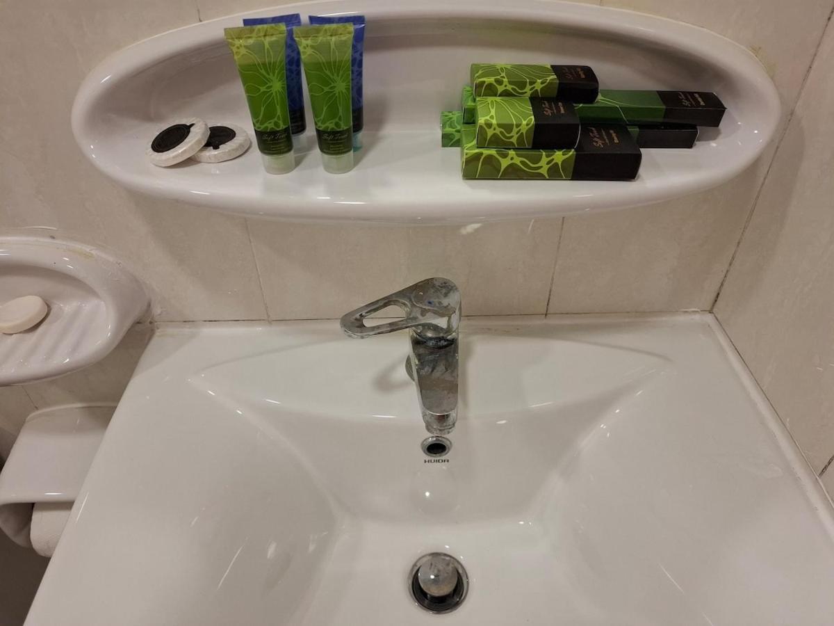 a sink with a faucet in a bathroom at Cozy rustic el carro Apartment in Umm ash Shajar