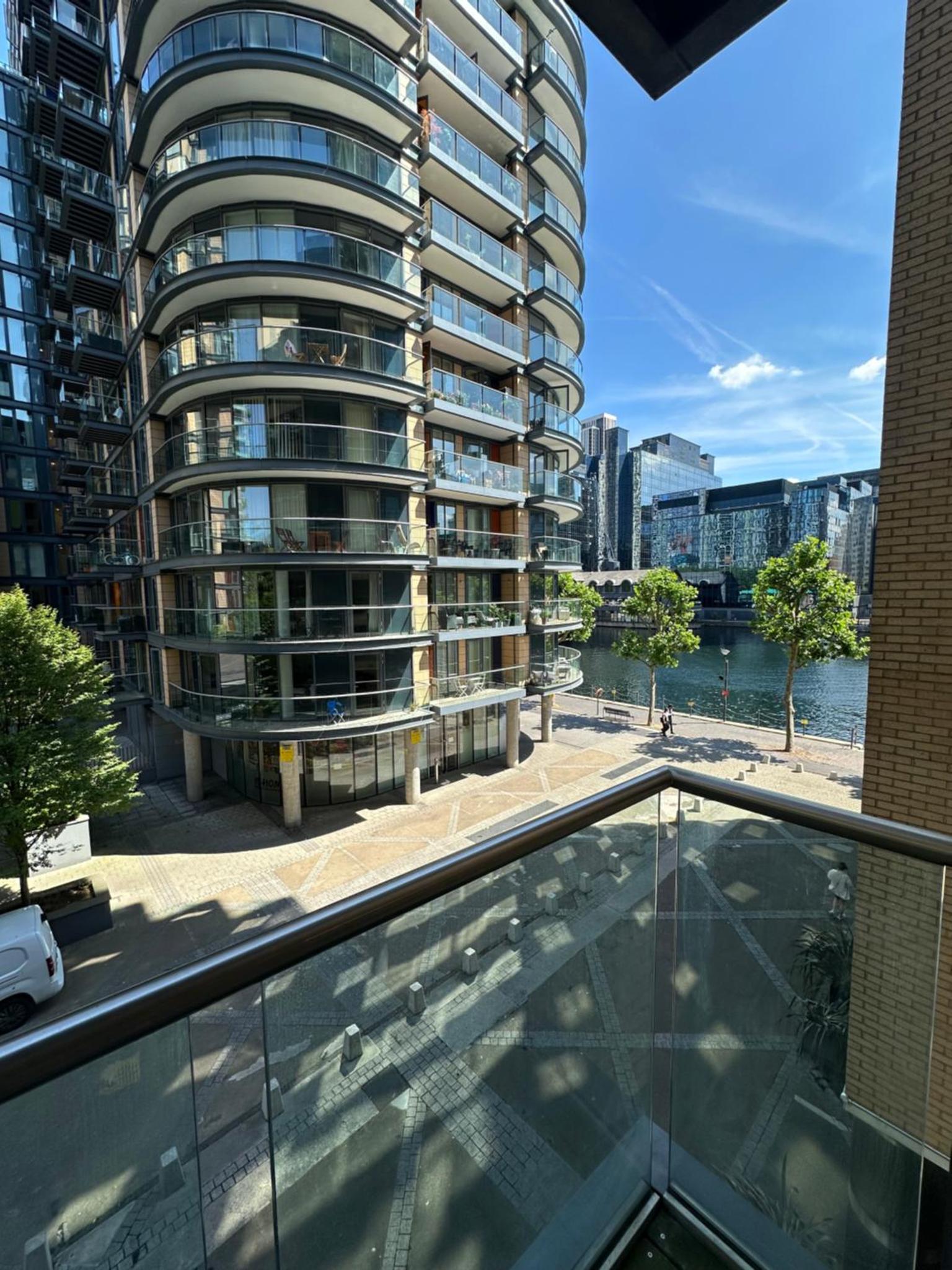 a glass balcony with a view of a building at Canary Wharf - Luxury Apartments in London