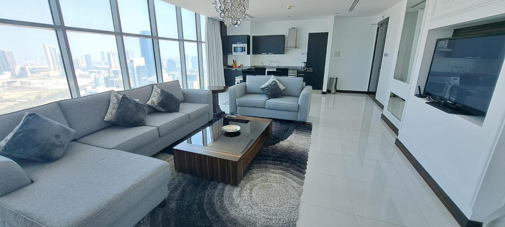a living room with a couch and a table at Seef Residence in Seef