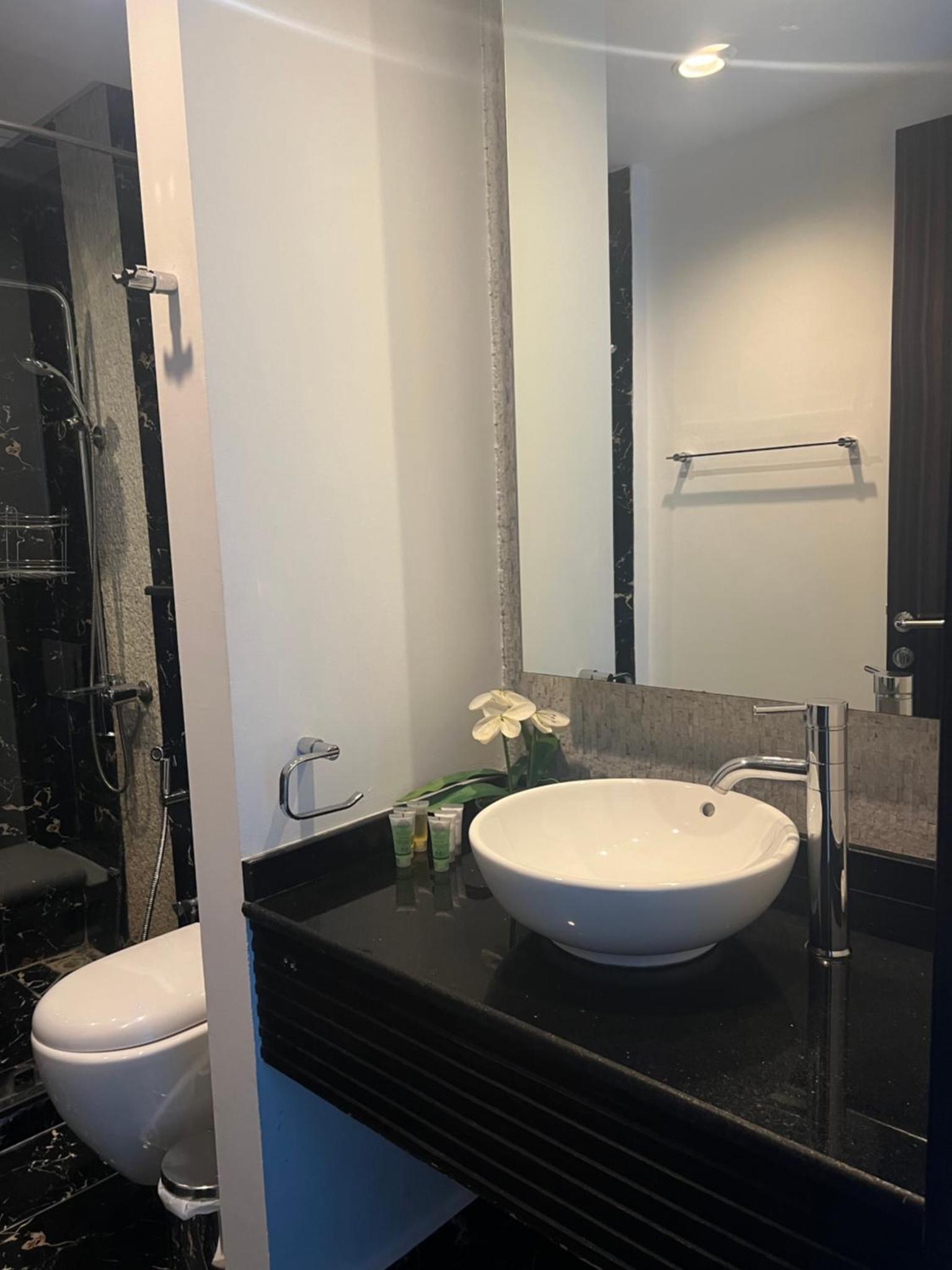 a bathroom with a sink and a toilet at Seef Residence in Seef +35 photos