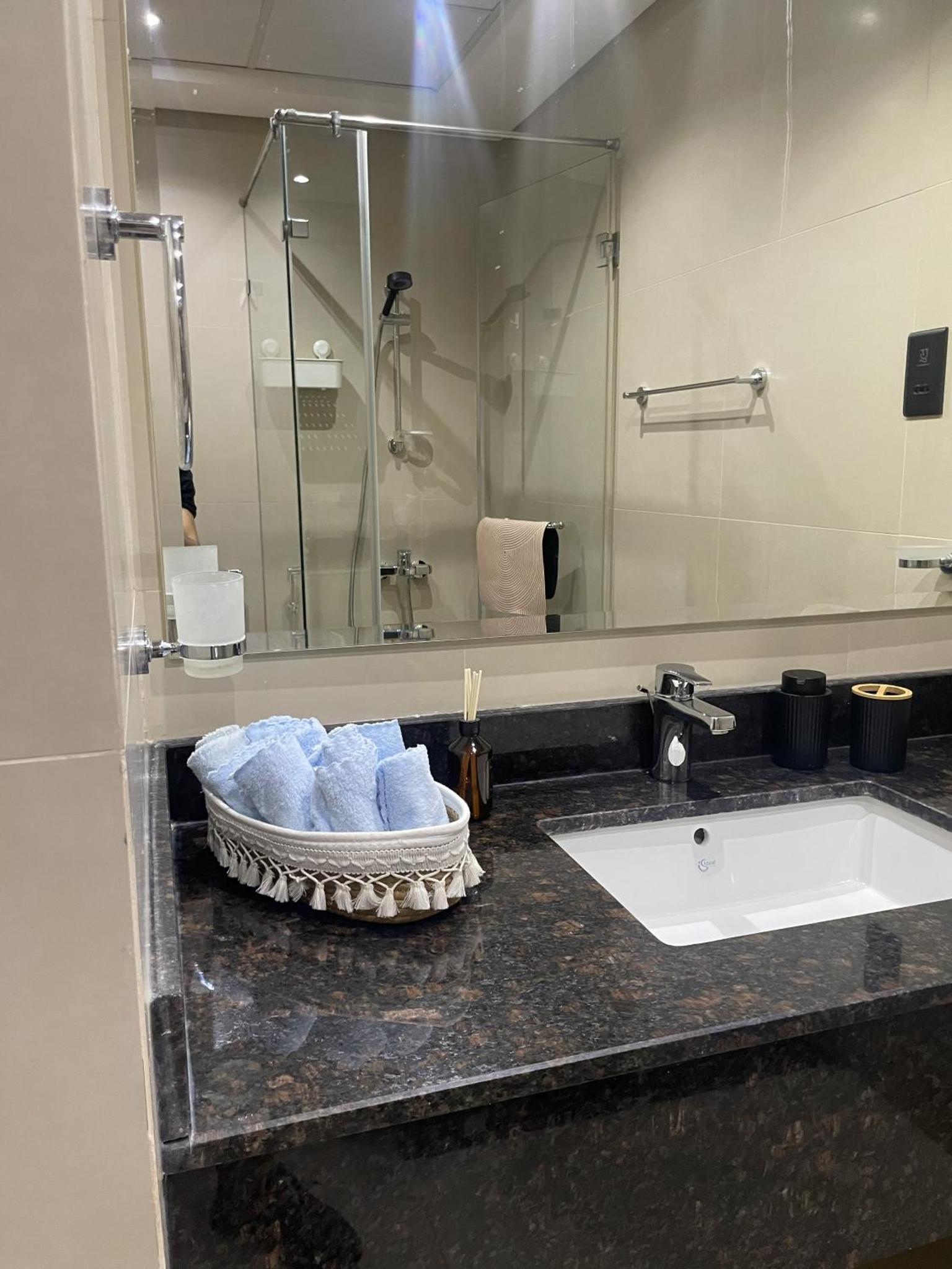 a bathroom with a sink and a shower at Boho Cozy Escape in Quiet Neighborhood in Sanābis