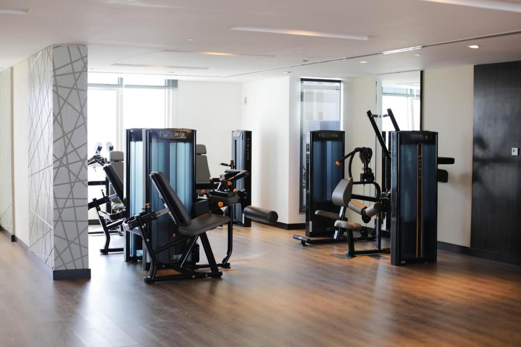 a gym with treadmills and cardio equipment in a room at Boho Cozy Escape in Quiet Neighborhood in Sanābis