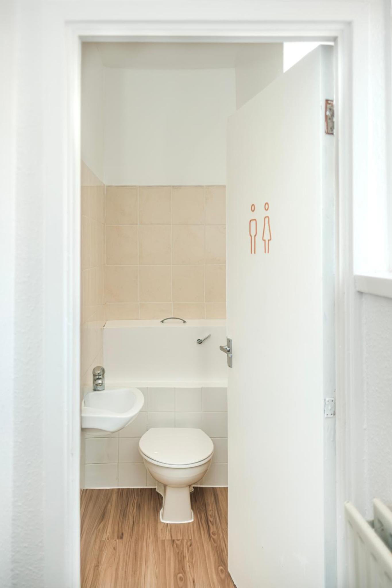a bathroom with a toilet and a sink at 3 of 5 Room Cozy, spacious and modern in Camden Town in London