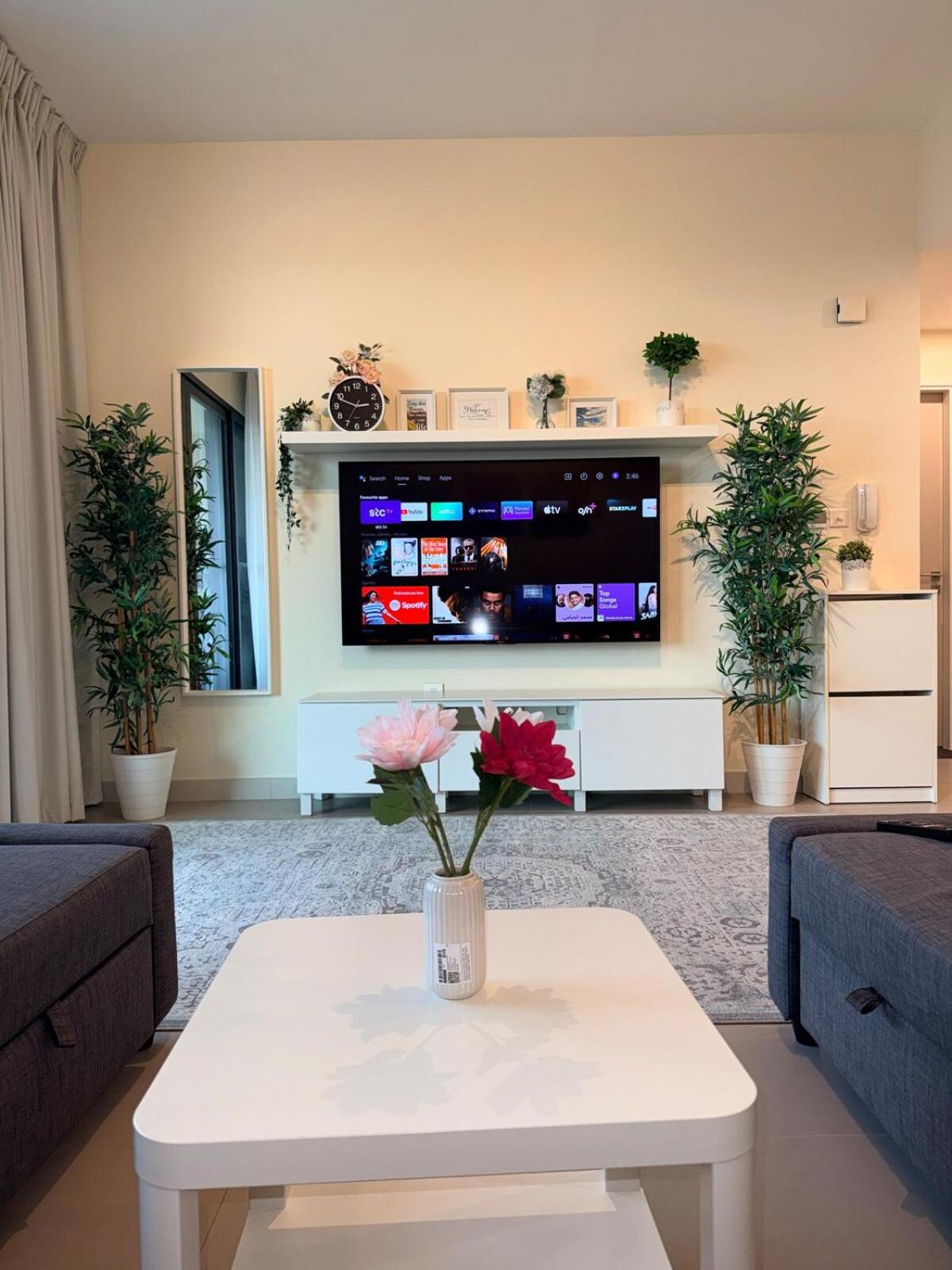 a living room with a tv and a white coffee table at A lavishly furnished one bedroom flat at Marassi in Muharraq