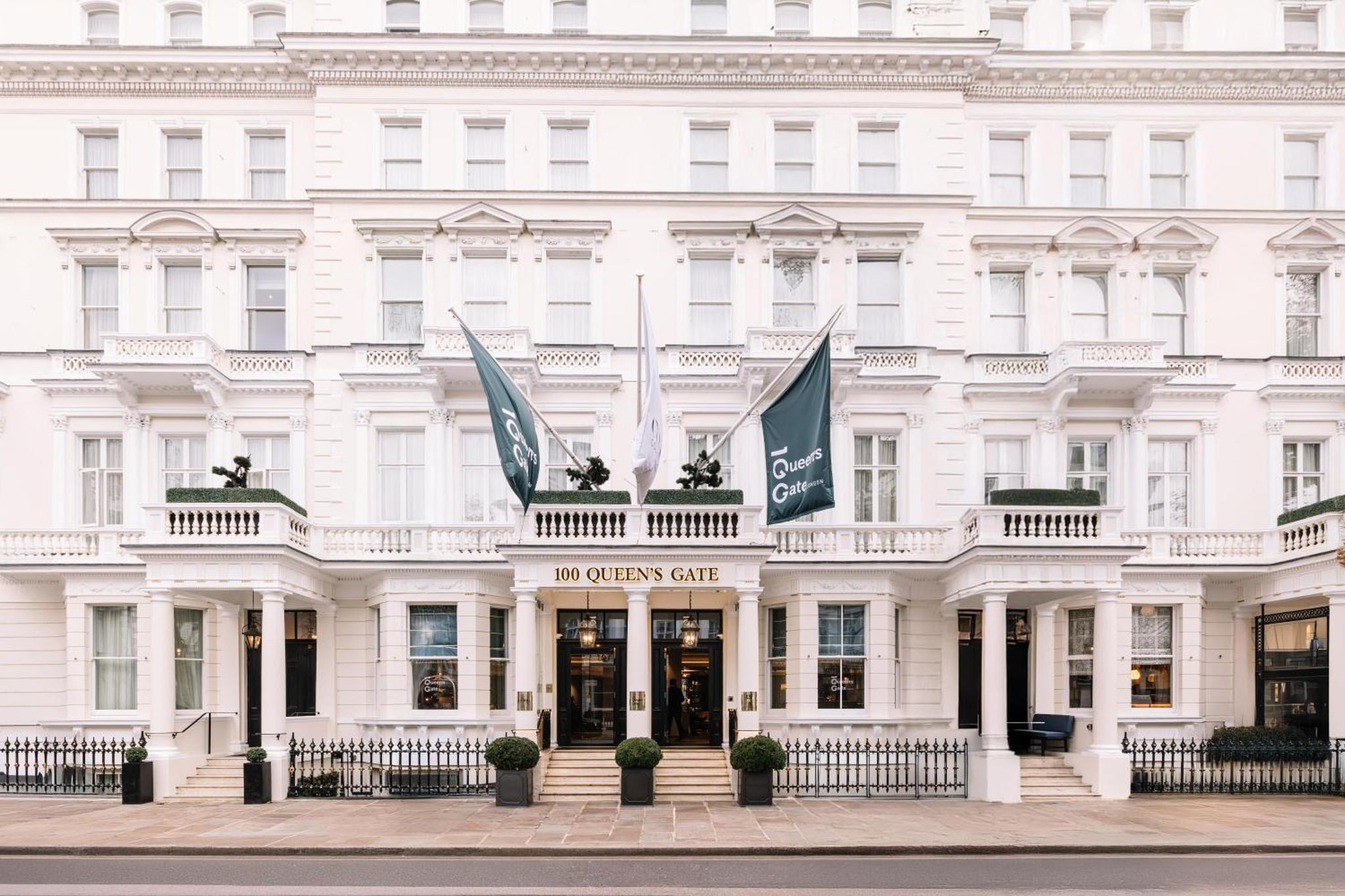 a white building with flags in front of it at 100 Queen's Gate Hotel London Kensington, Curio Collection by Hilton in London