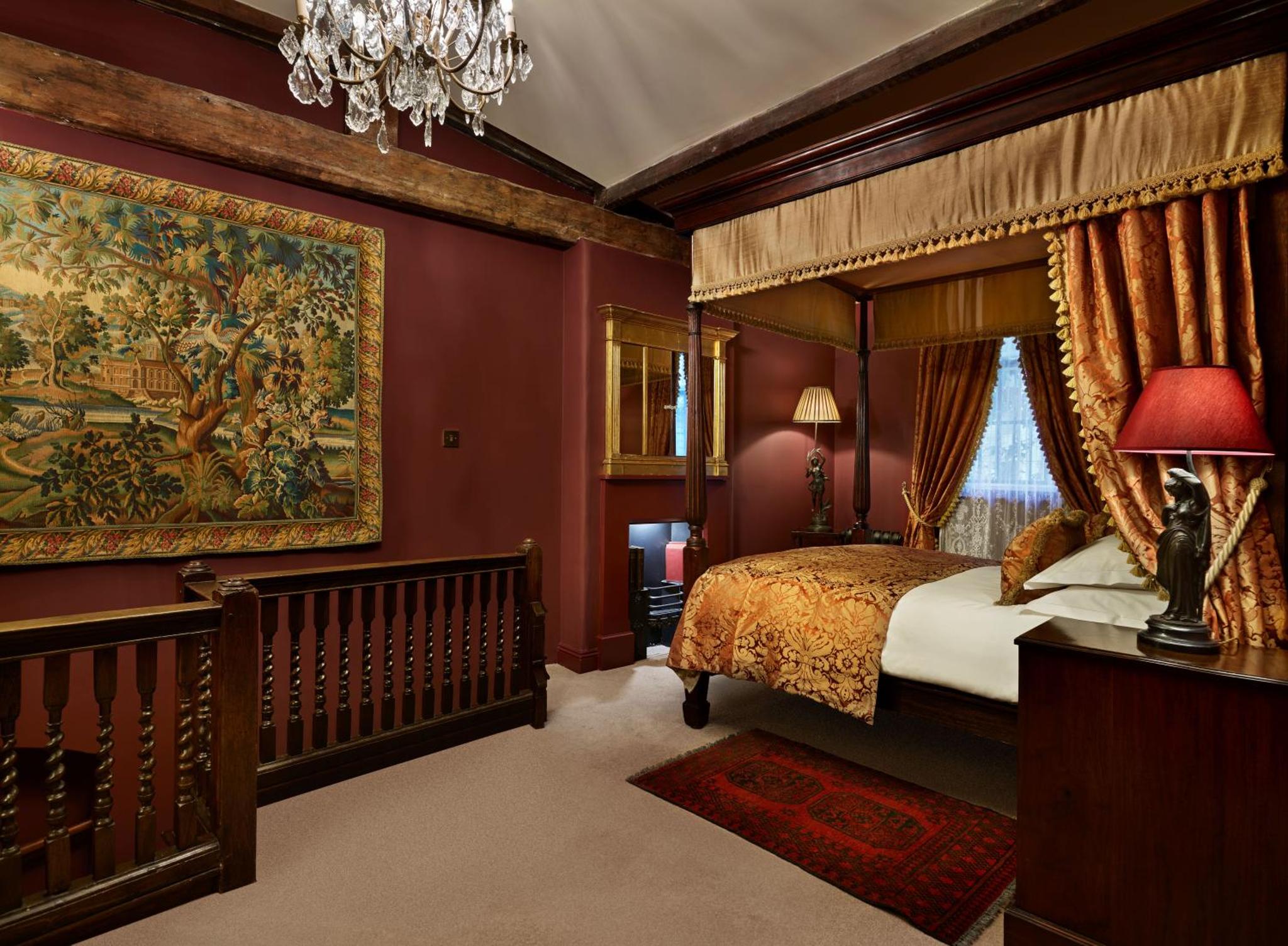 a bedroom with a canopy bed and a large tapestry at The Rookery in London