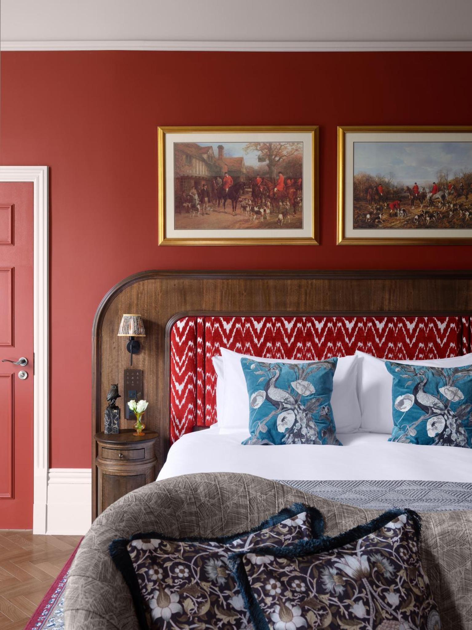 a bedroom with a bed with two pictures on the wall at Bertrand's Townhouse in London