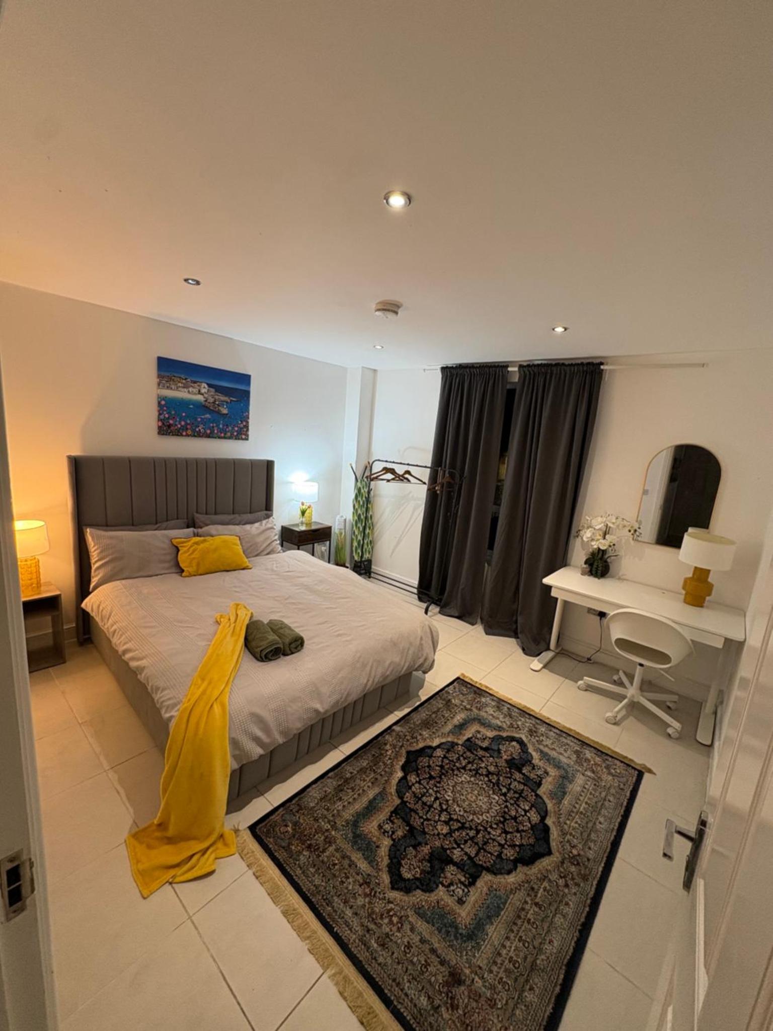 a bedroom with a bed and a desk in it at Tower Bridge Luxury Apartment with Balcony in London
