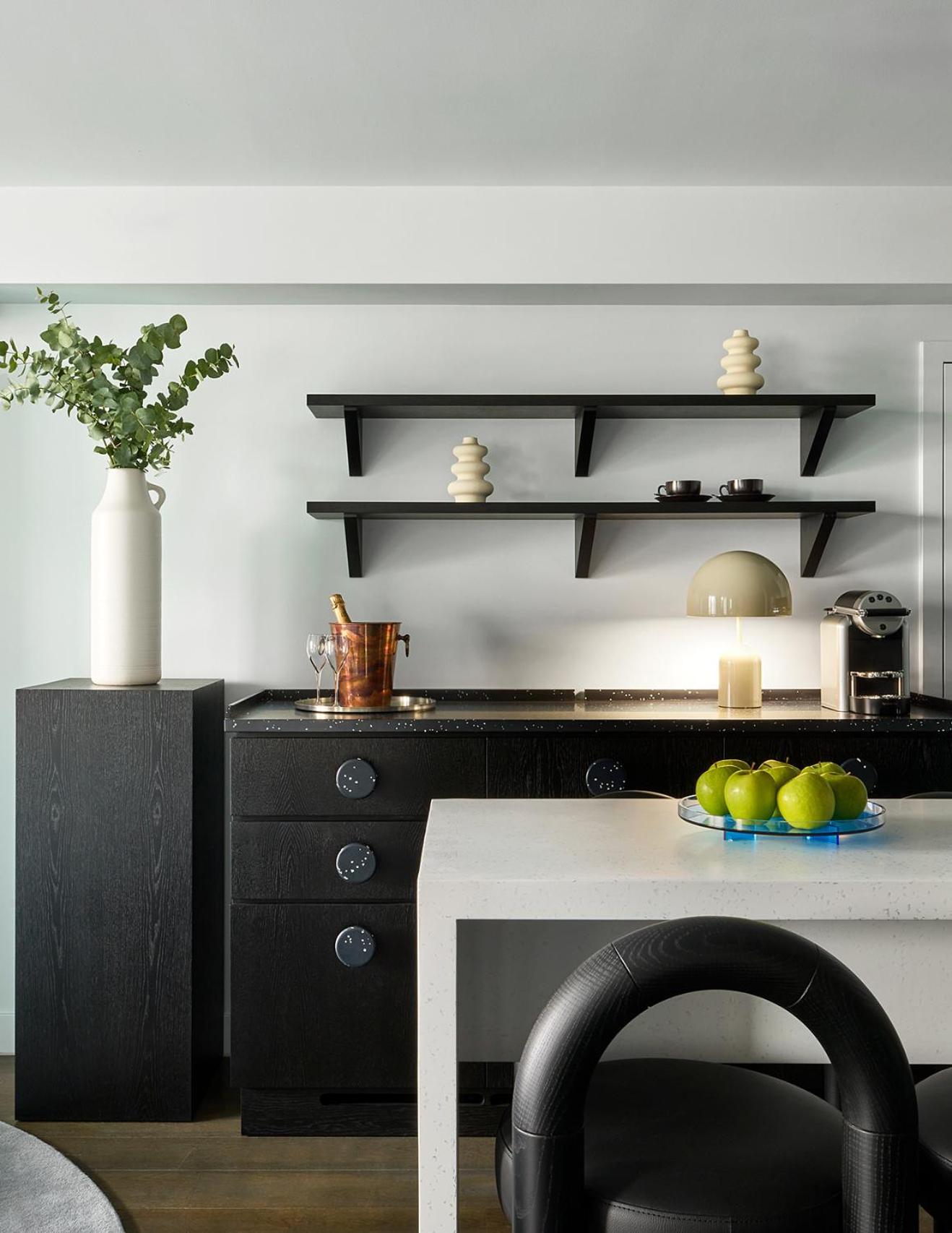 a table with a bowl of fruit on top at Sea Containers London in London