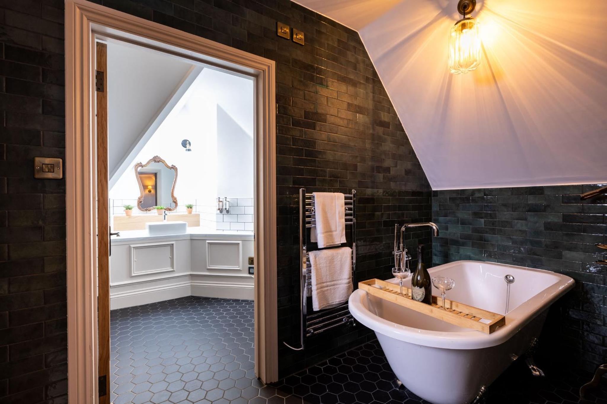 a bathroom with a large tub and a sink at The Red Lion Hotel in London +21 photos