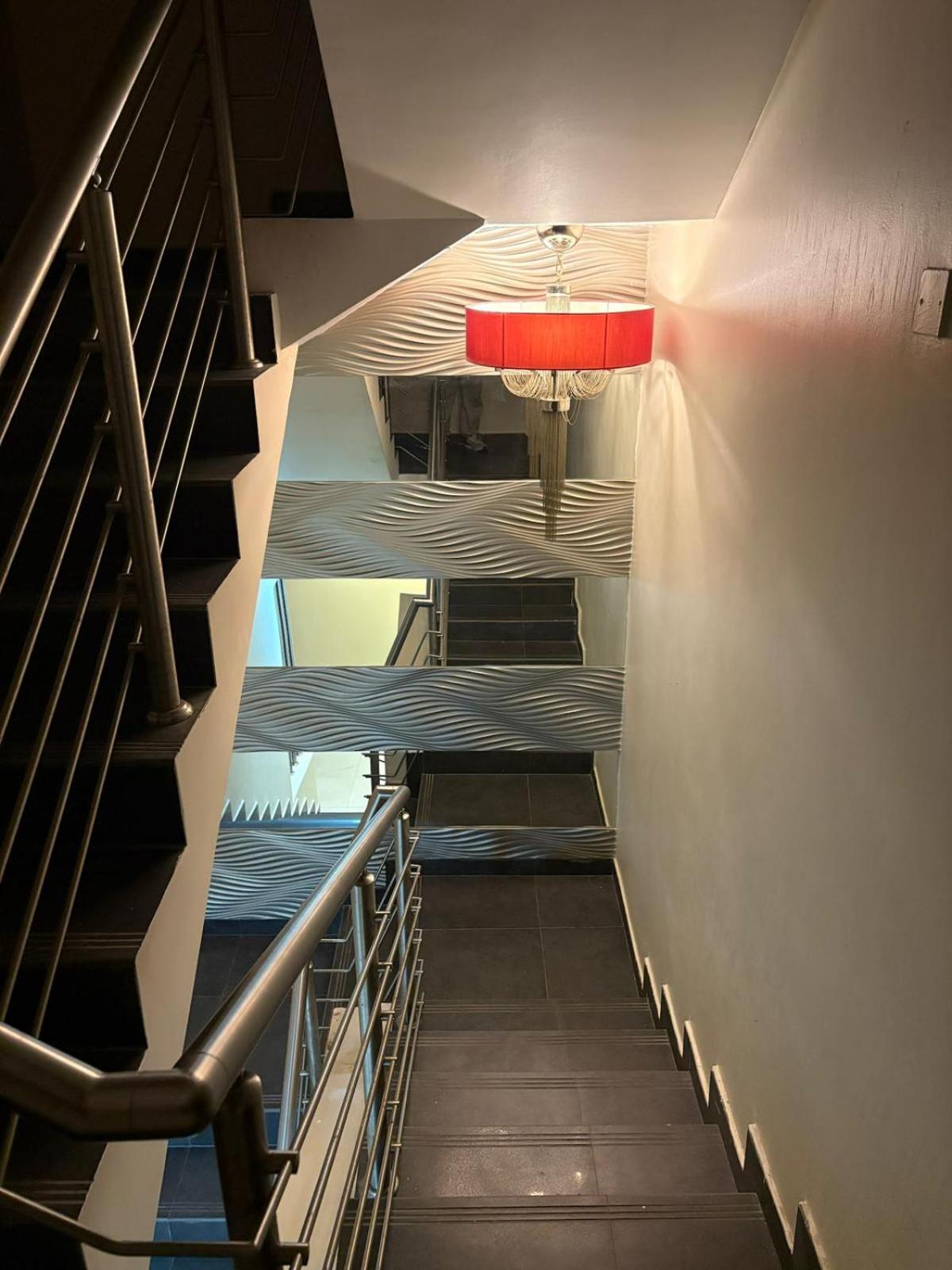 a staircase in a building with a red light at شاليةسرايا البحر4 غرف نوم مسبح خاص وبحر in Amwaj Island +4 photos