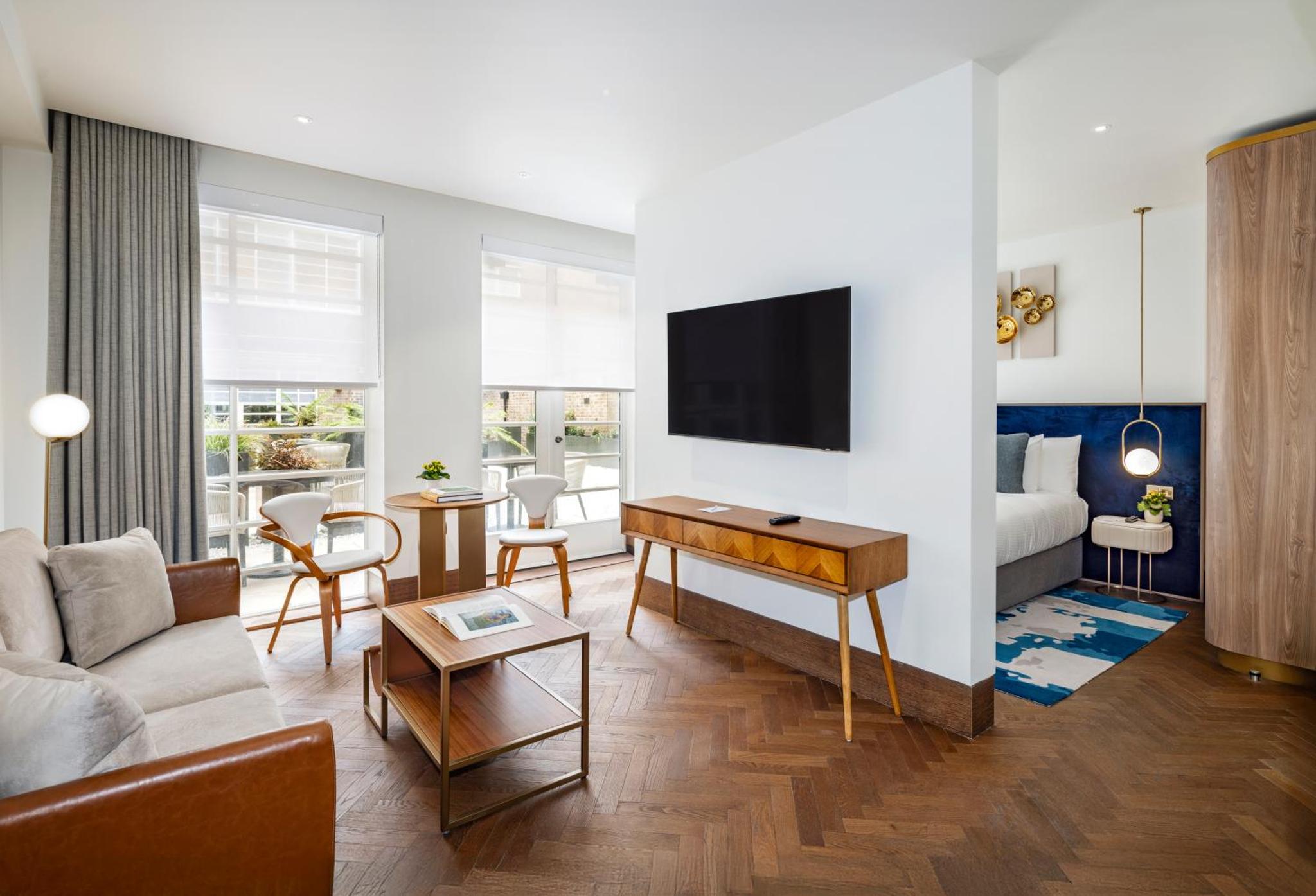 a living room with a couch and a table at Dao by Dorsett North London in London