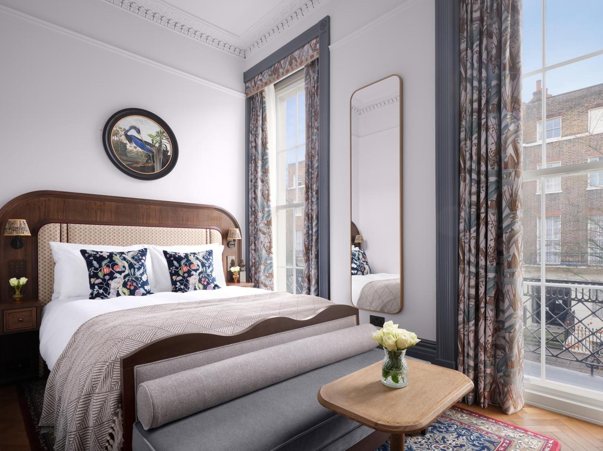 a bedroom with a large bed and a window at Bertrand's Townhouse in London