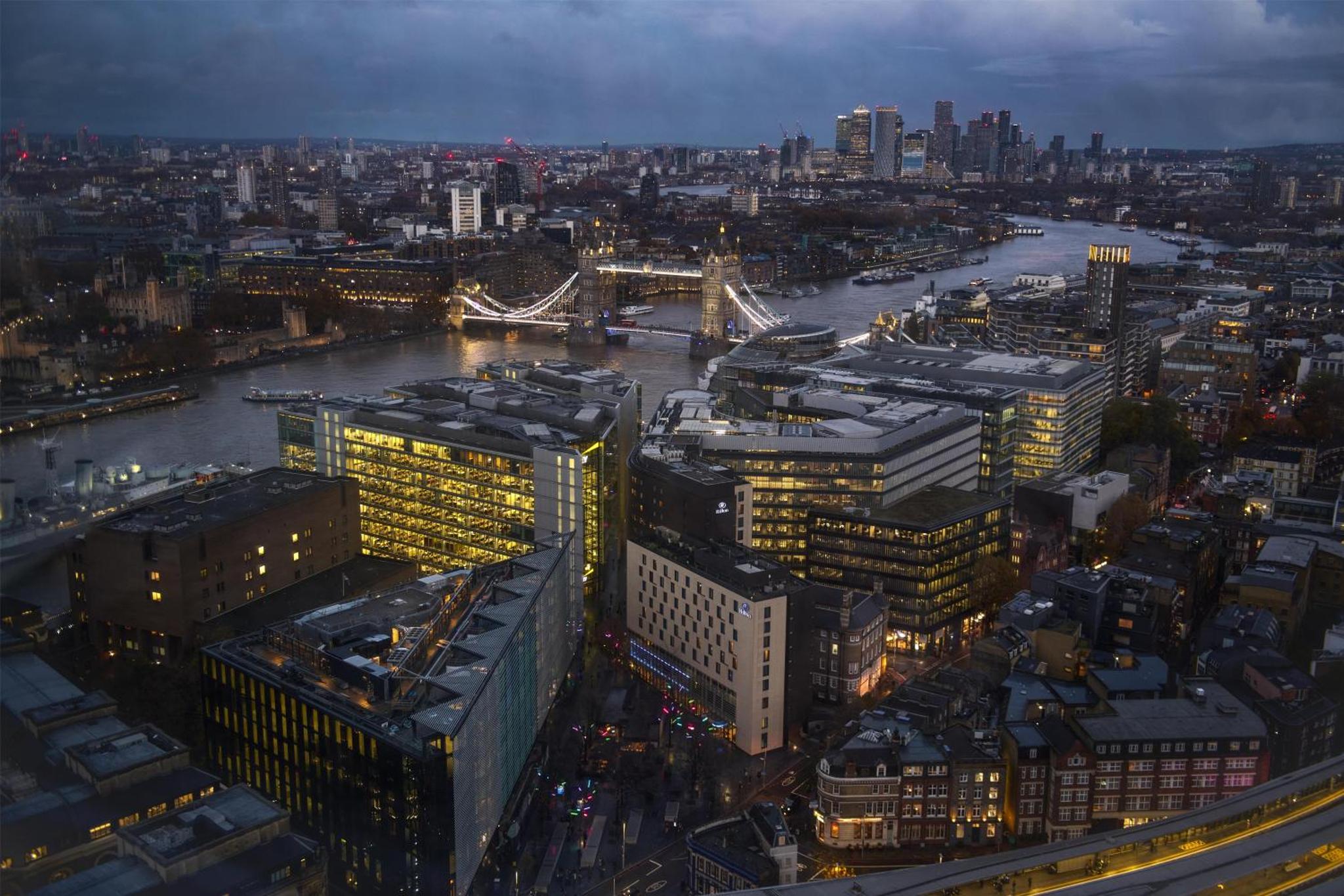 an aerial view of a city with a river and buildings at Hilton London Tower Bridge in London