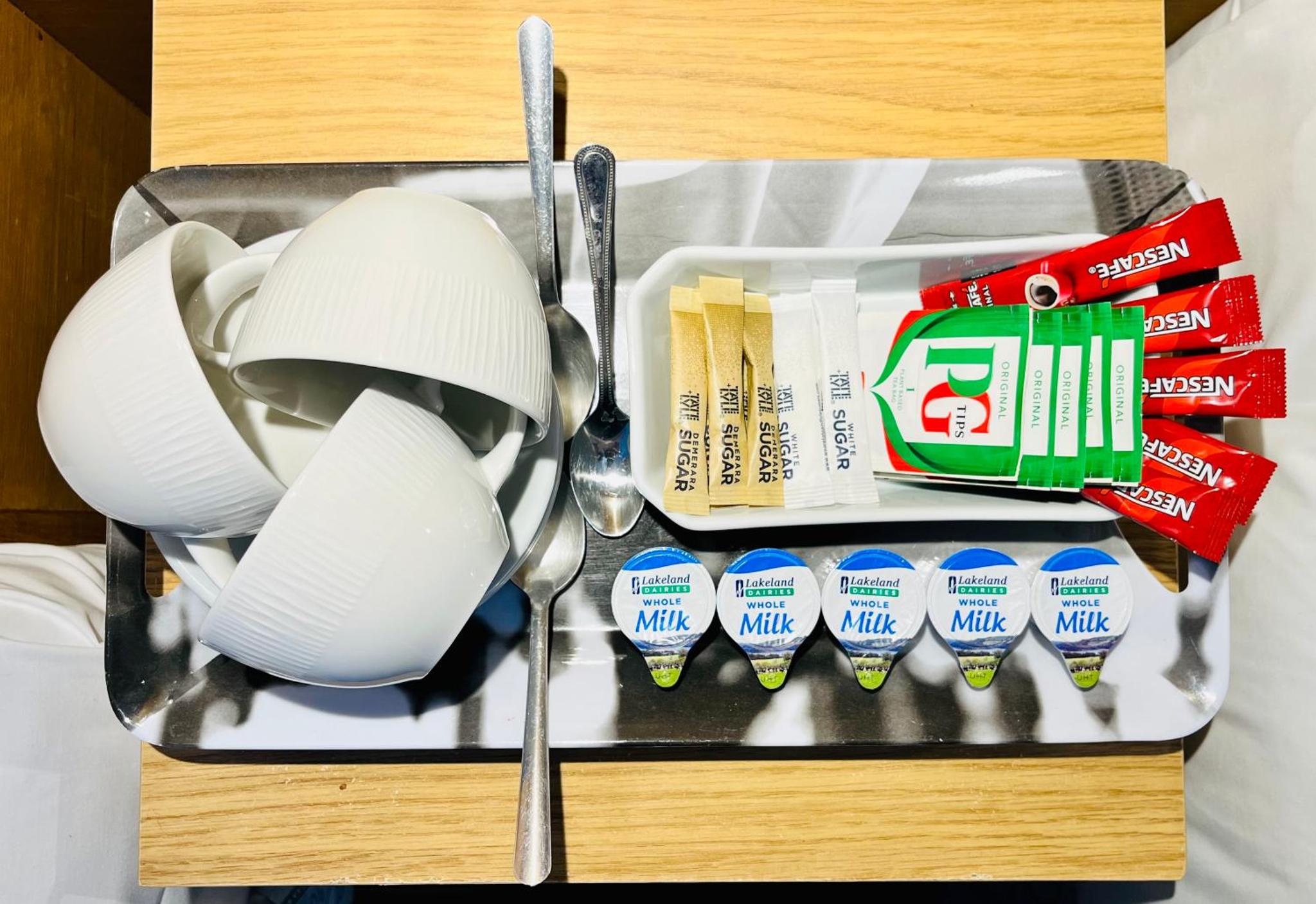 a tray with cups and toothbrushes on a table at West Cromwell Hotel in London +31 photos