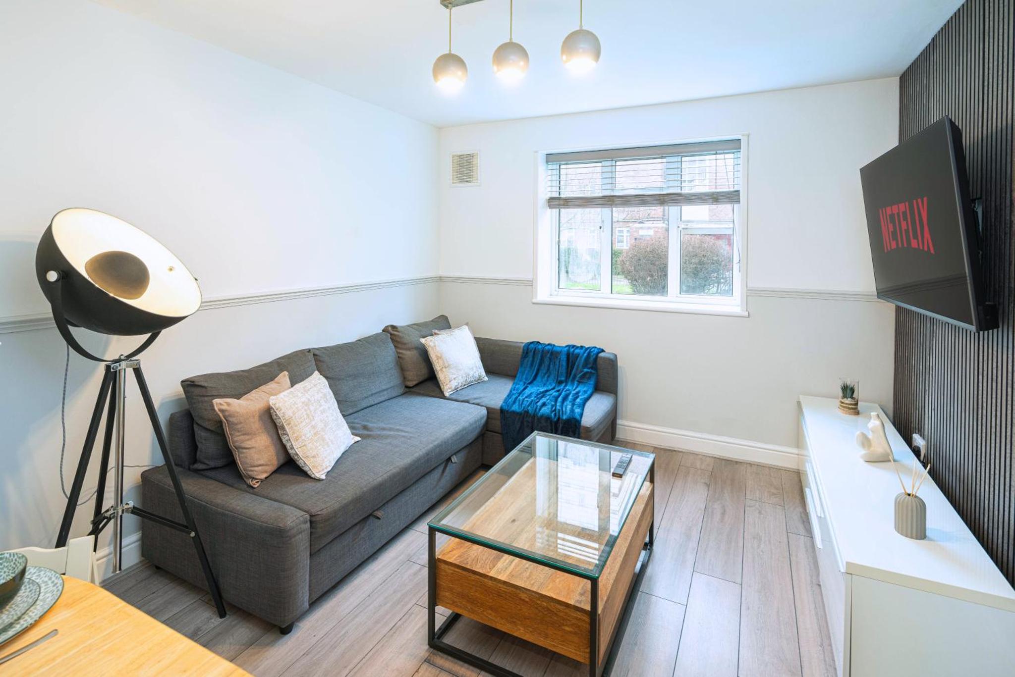 a living room with a couch and a table at Modern 3BR with Fast Links to Central London in London
