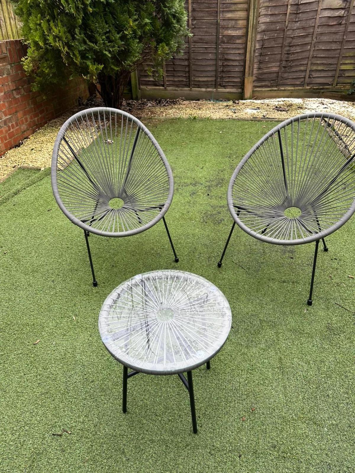 two metal benches with a table on the grass at Sizzling London Studio with Jacuzzi & Private Bath in London