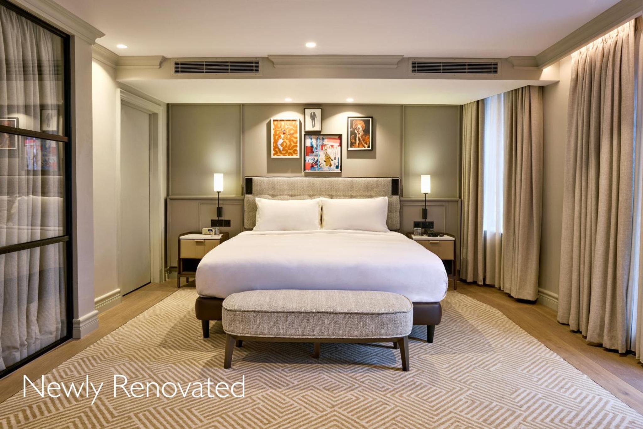 a bedroom with a large bed and a large window at Radisson Blu Hotel, London Bond Street in London