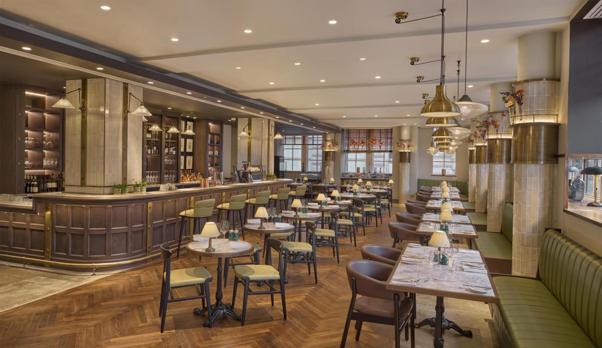a restaurant with tables and chairs and a bar at Hyatt Regency London Blackfriars in London