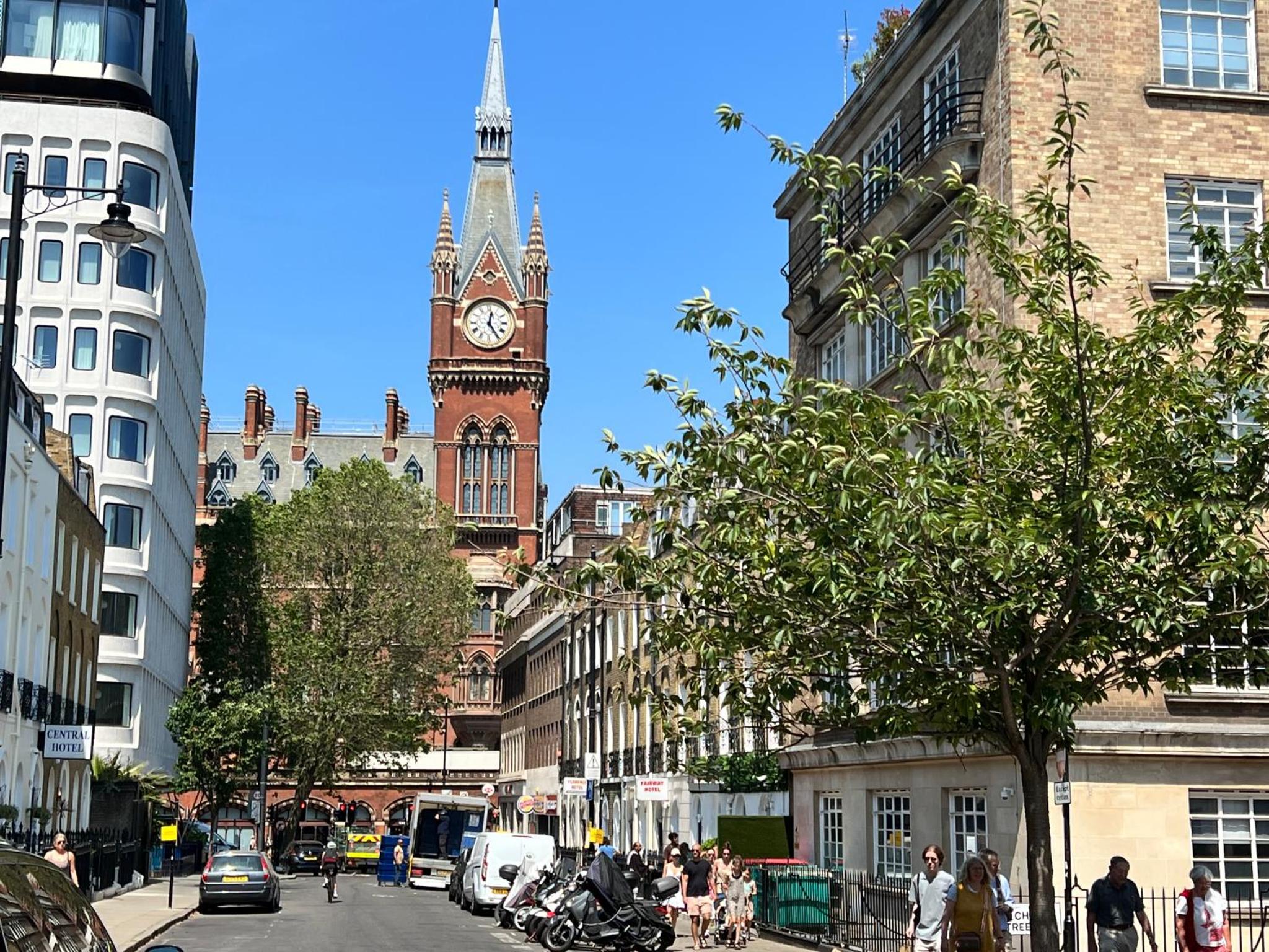 a clock tower in the middle of a city at The Suites - St Pancras Hotel Group in London