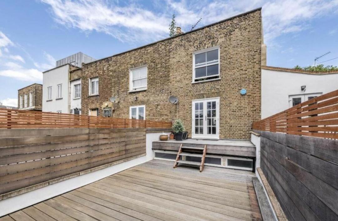 a house with a wooden deck in front of it at Spacious 1 Bed Maisonette in Camden by Amber Stays, Perfect for Long Term Stays, Sleeps 4 in London