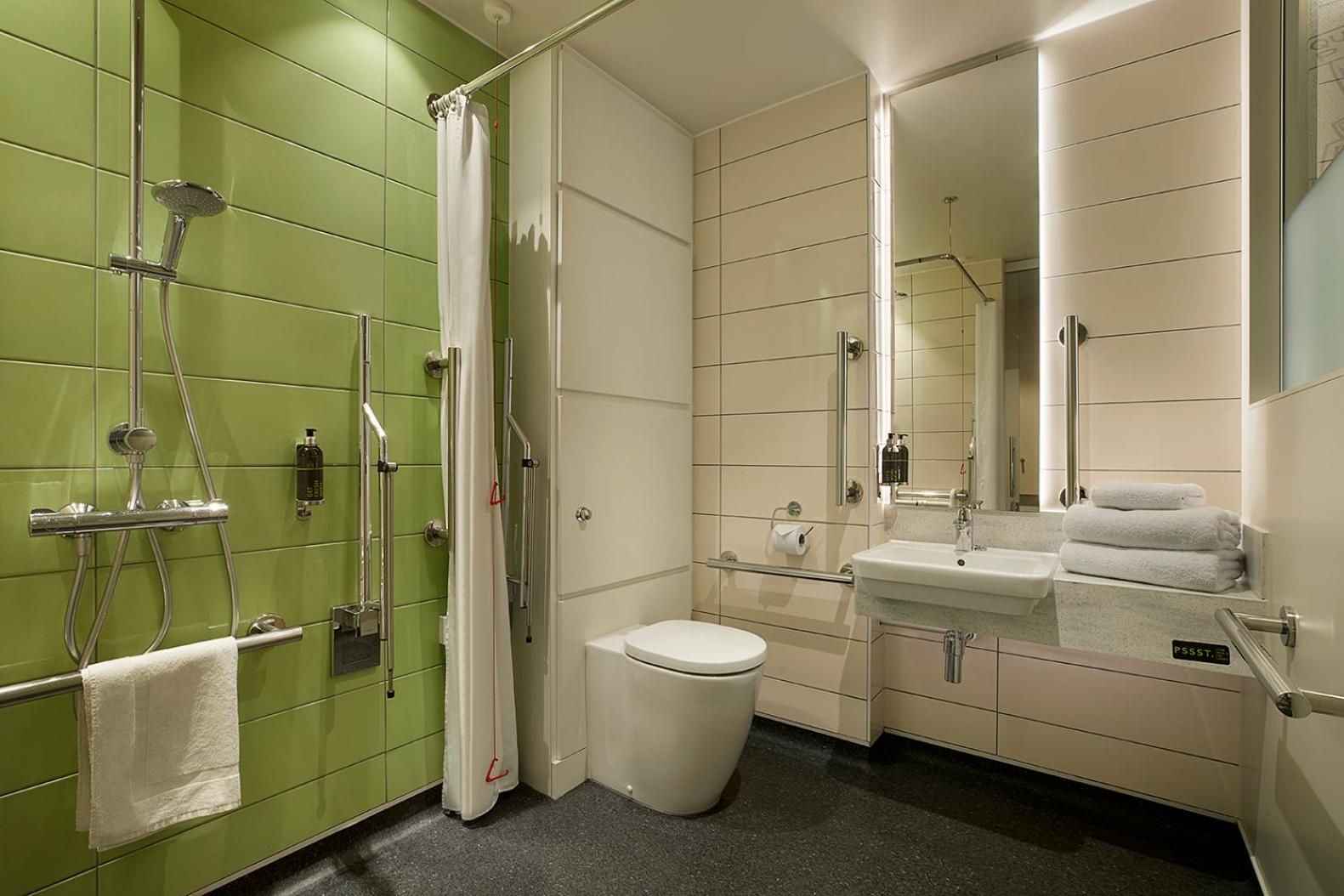 a bathroom with a toilet and a sink and a mirror at hub London - Marylebone in London
