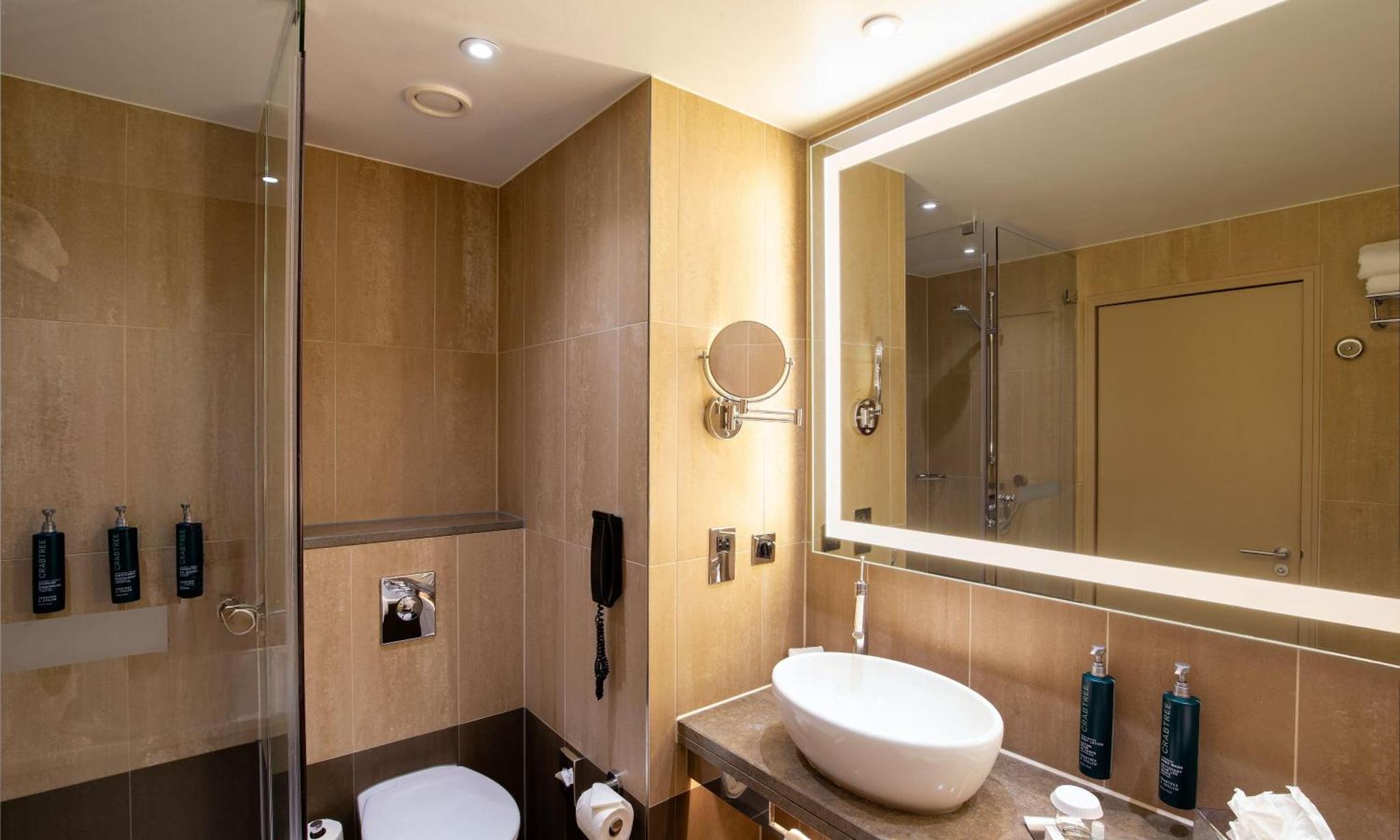 a bathroom with a sink and a mirror at Hilton London Tower Bridge in London