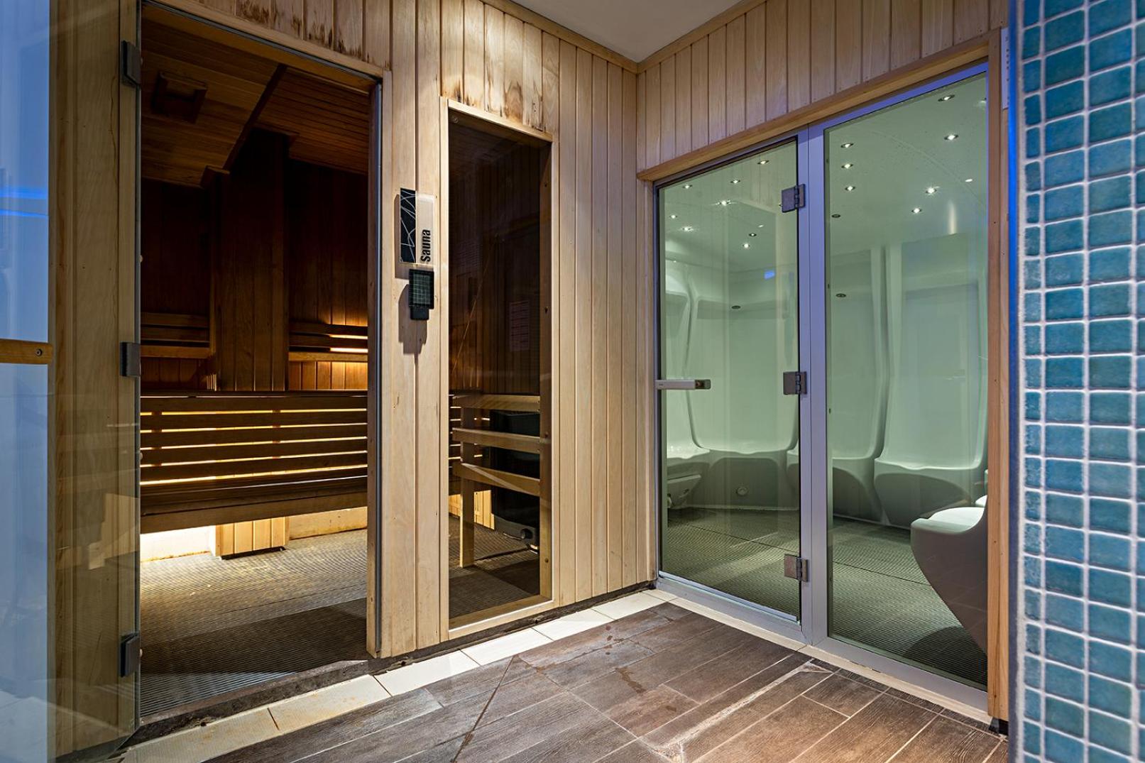 a bathroom with a glass door leading to a toilet at Pestana Chelsea Bridge Hotel & SPA in London