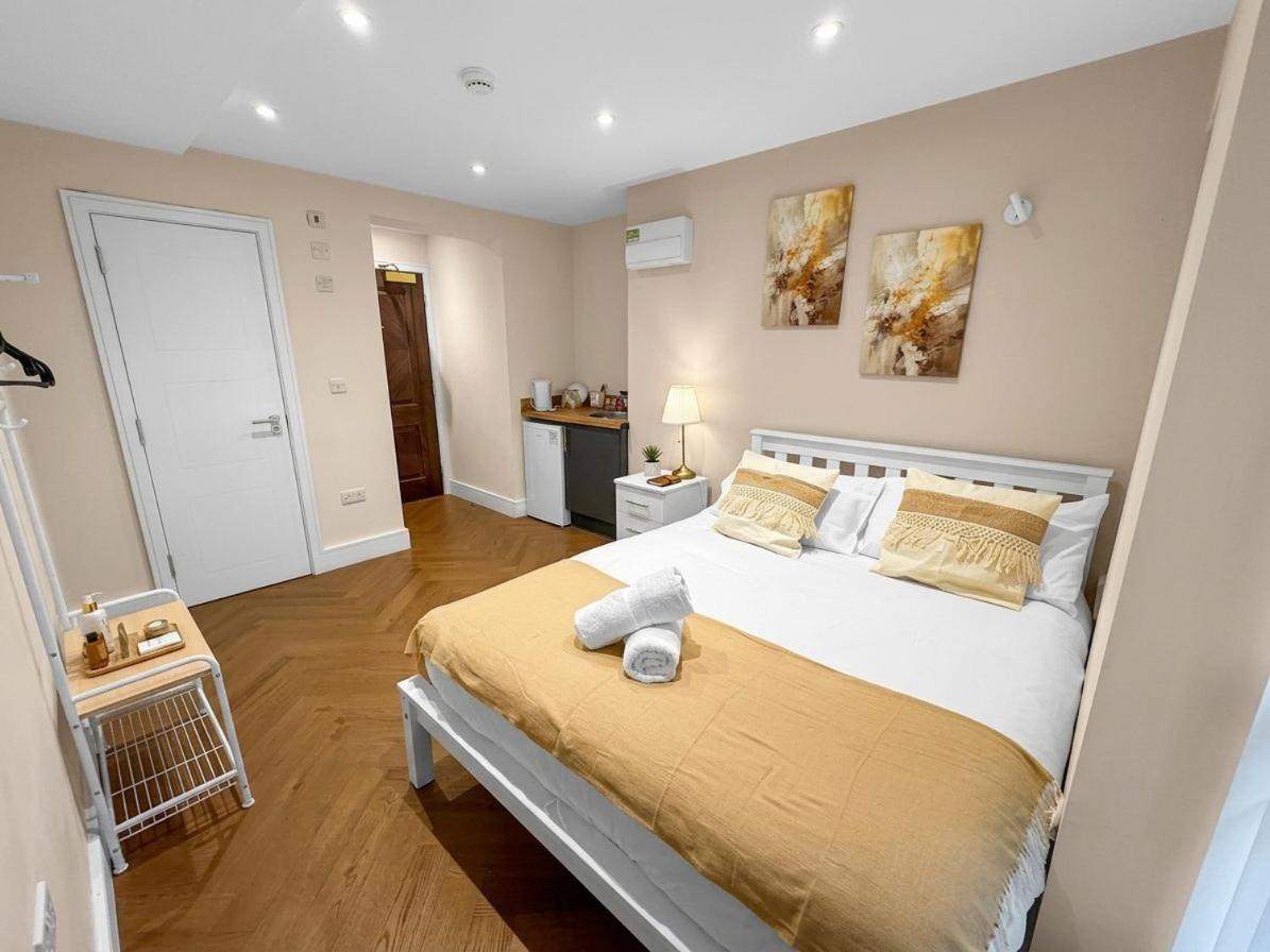 a bedroom with a large bed in a room at 30C The Luxury Studios near Arsenal and Central London in London