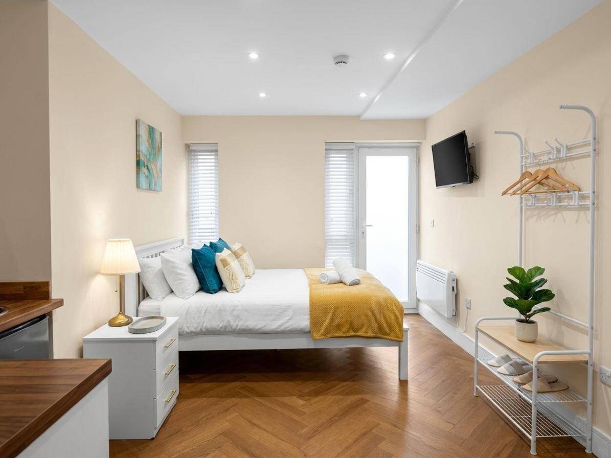 a bedroom with a bed and a tv on the wall at 30B The Lux Studios Near Arsenal and Central London in London