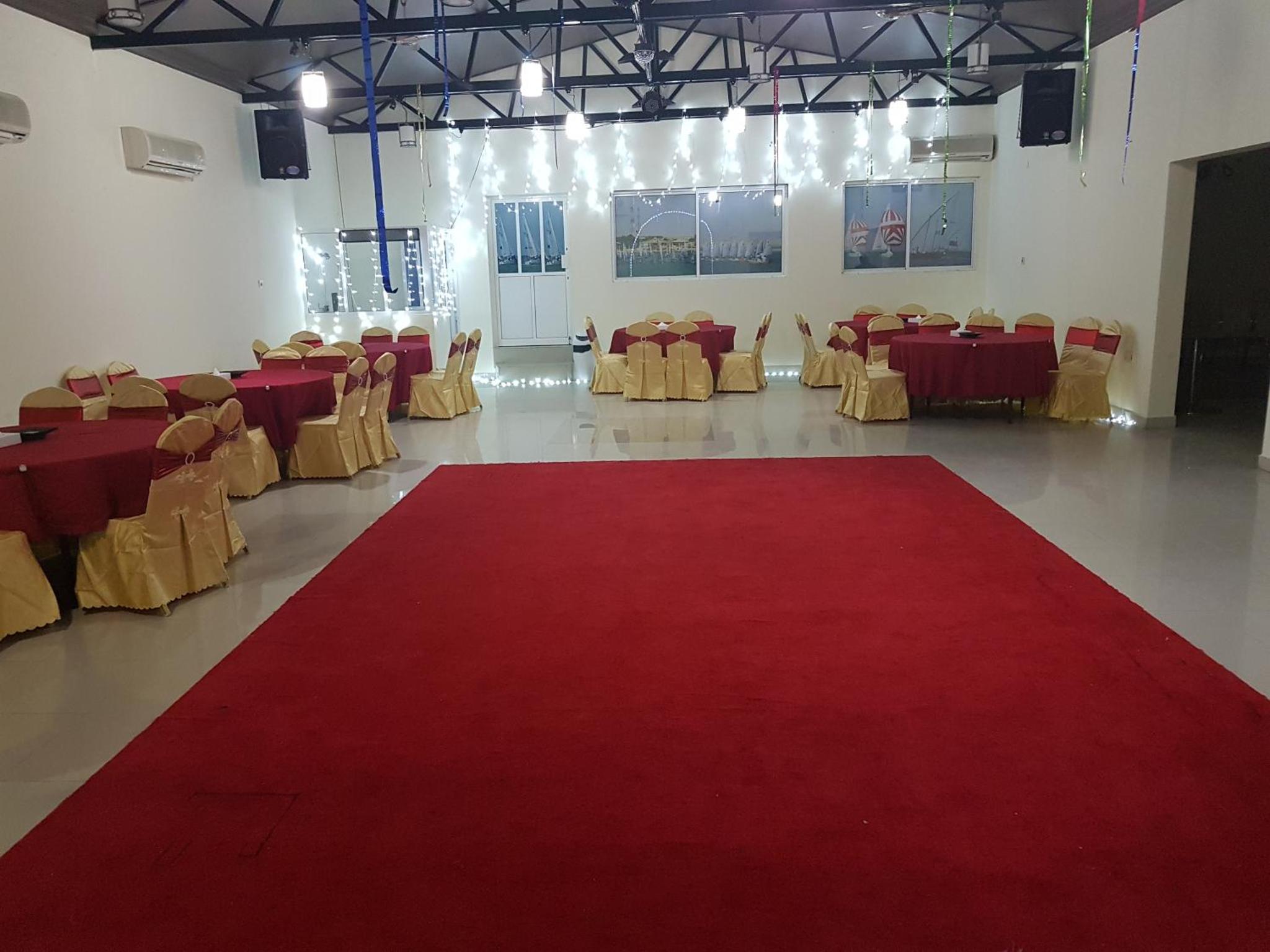 a large red carpet in a room with tables and chairs at Bahrain Beach Bay in Az Zallāq +63 photos