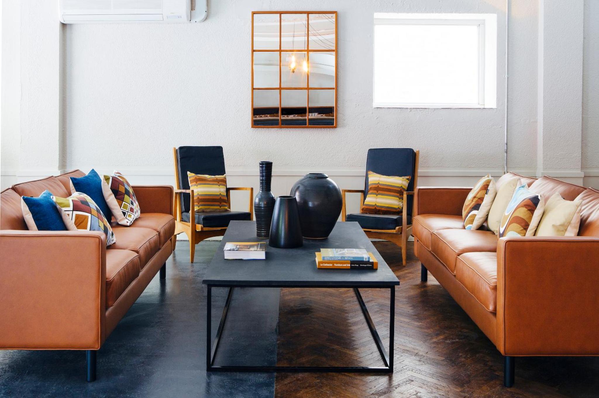 a living room with couches and a coffee table at Green Rooms in London