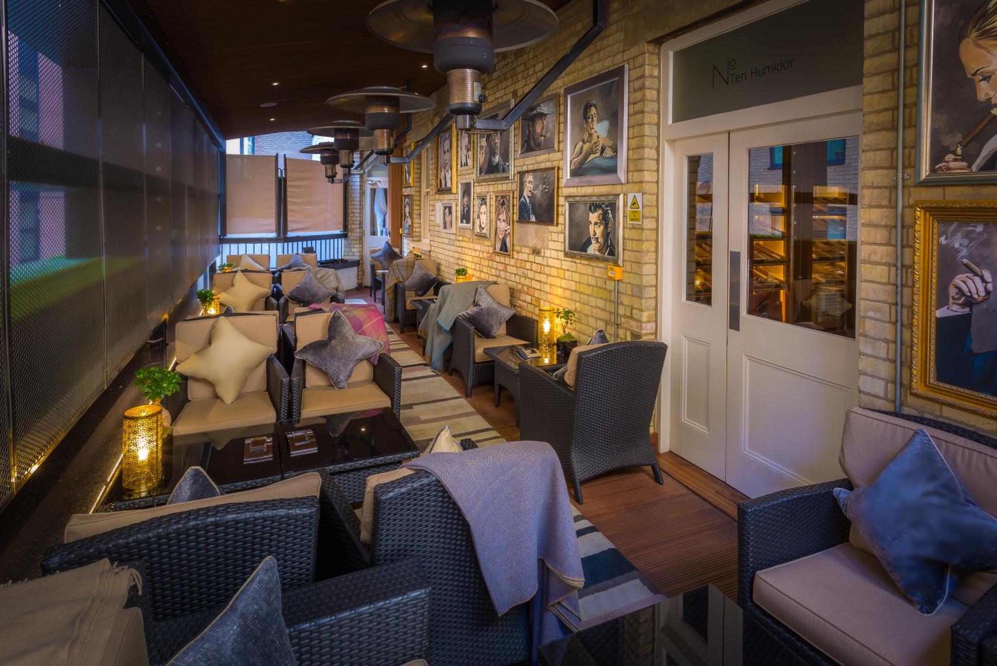 a restaurant with couches and chairs in a room at Ten Manchester Street Hotel in London