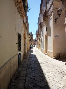 an empty alley with buildings and a street at Affittacamere Room and Breakfast Antonuccio in Alessano