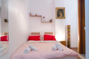 a bedroom with a bed with two towels on it at Aristotelous street small apartment in Thessaloniki