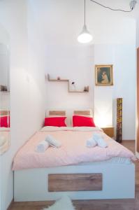 a bedroom with a bed with two slippers on it at Aristotelous street small apartment in Thessaloniki