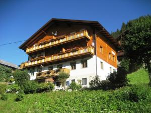 a large building with balconies on the side of it at Ferienwohnungen Böhm in Sankt Jakob in Defereggen